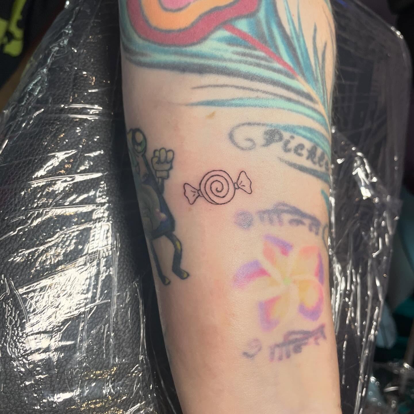 Candy and flower new school tattoo on the forearm by ‧₊˚ ☁️⋅♡ ‧₊