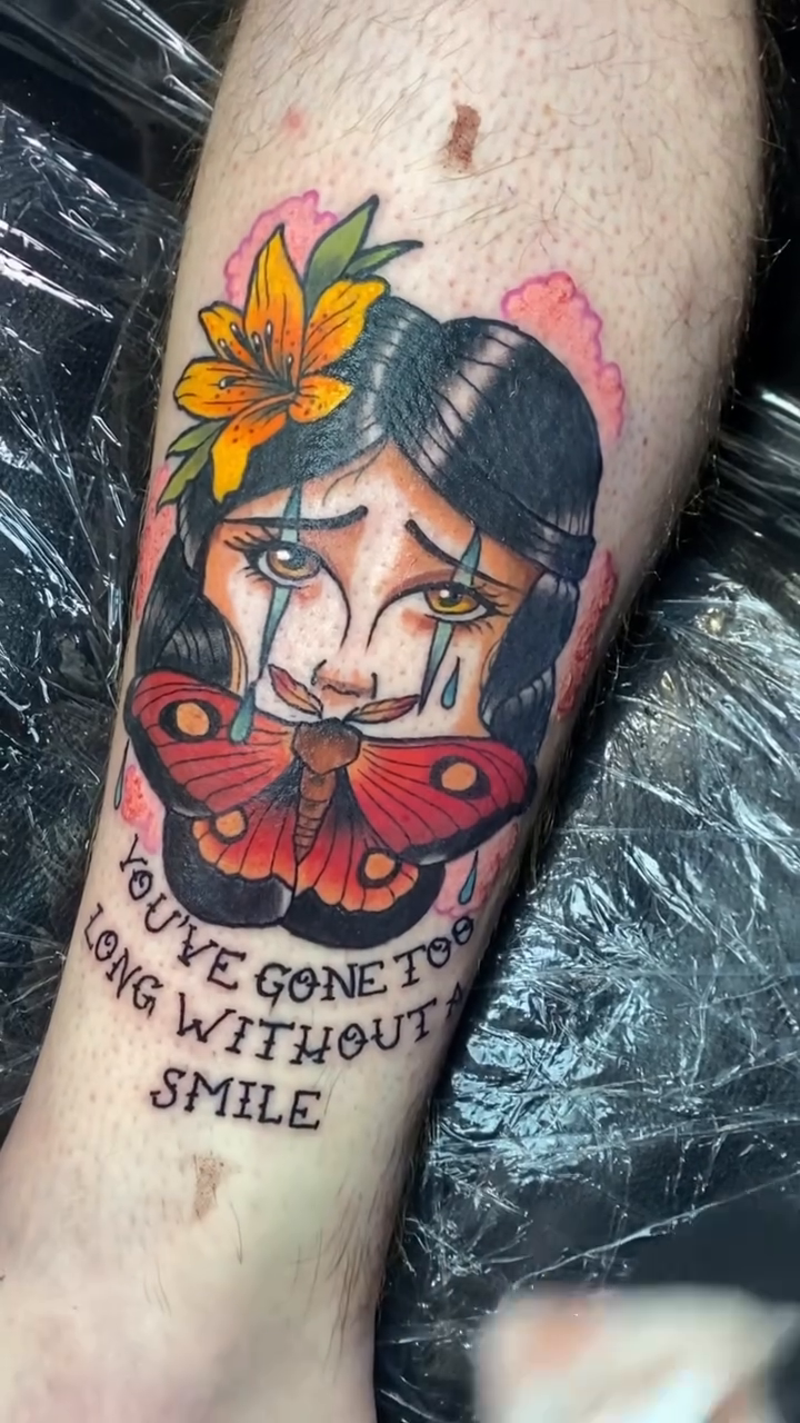Traditional crying woman with butterfly neo-traditional tattoo on the forearm by Ian Dorman