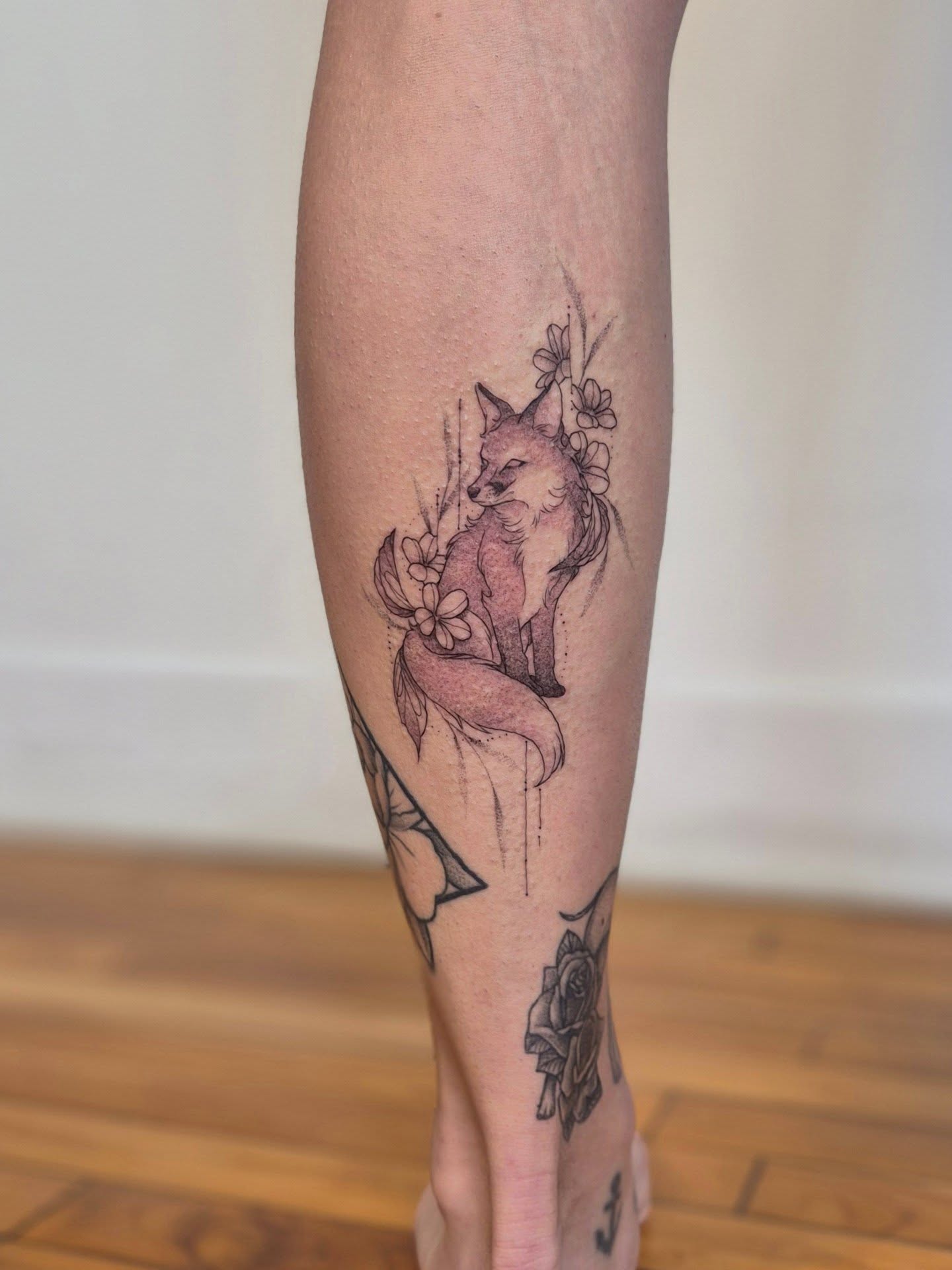 Fox and flowers black and grey tattoo on the calf by Sophorn Long (soapy)