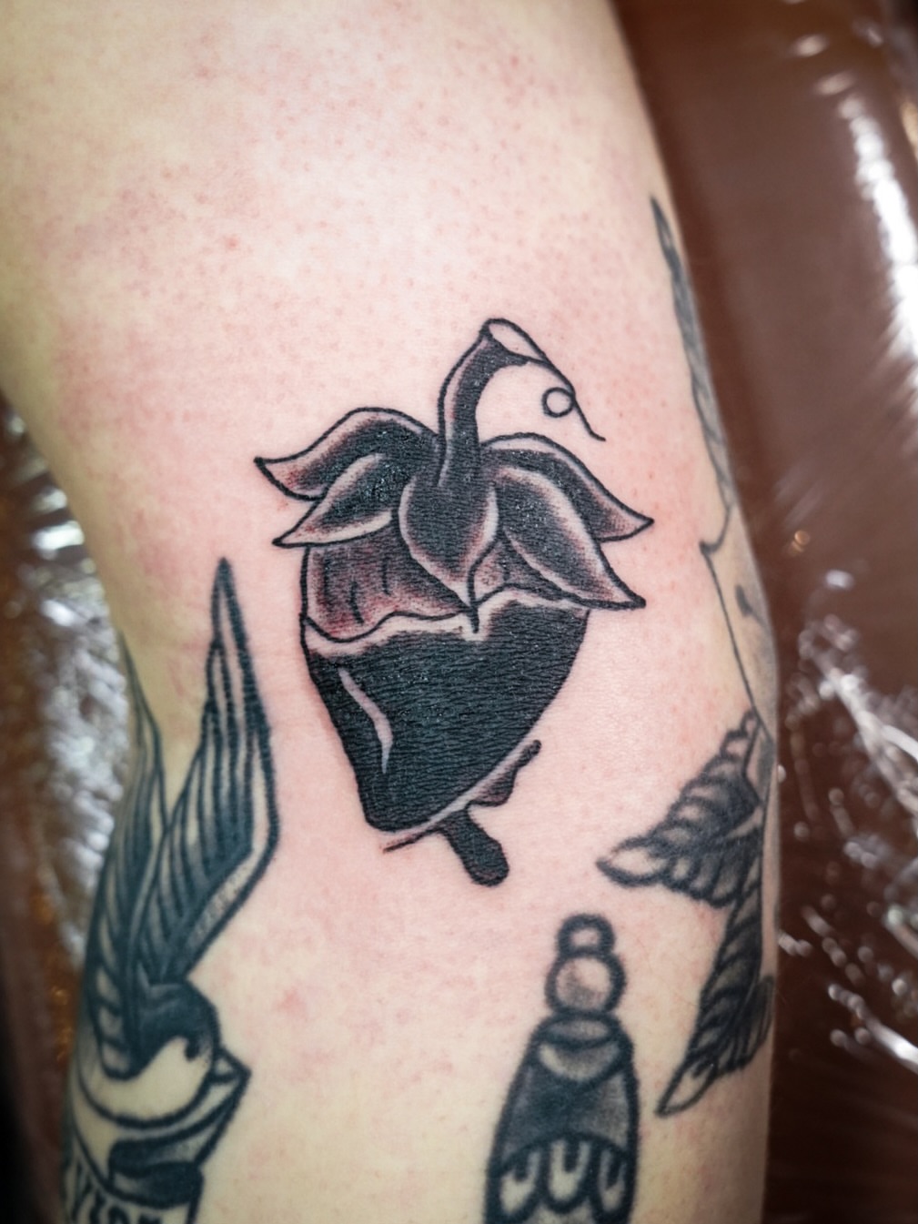 Heart with bird black and grey tattoo on the forearm by Spicoli