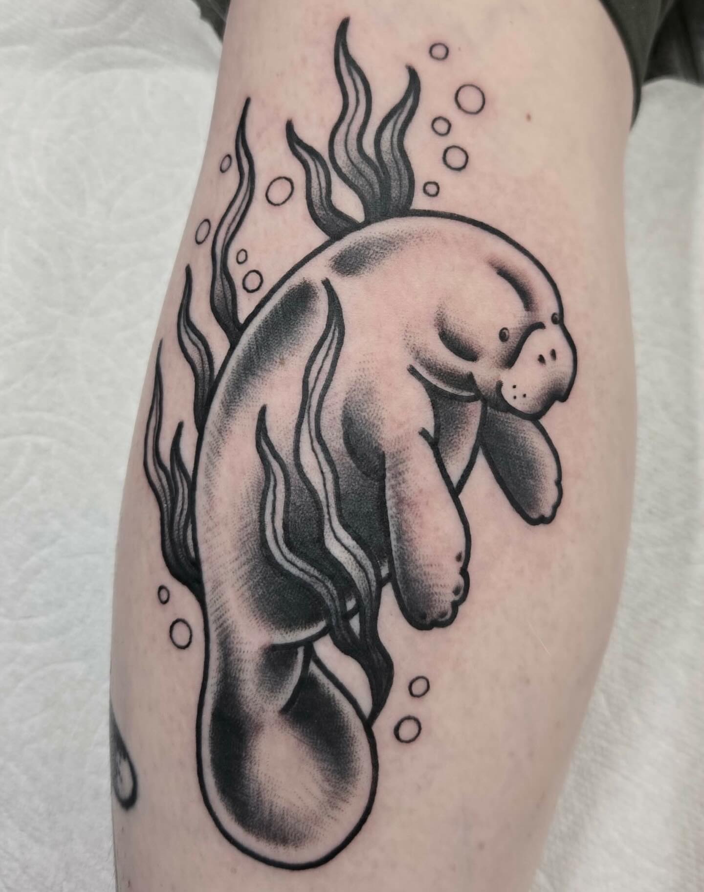 Manatee black and grey tattoo on the forearm by ๐