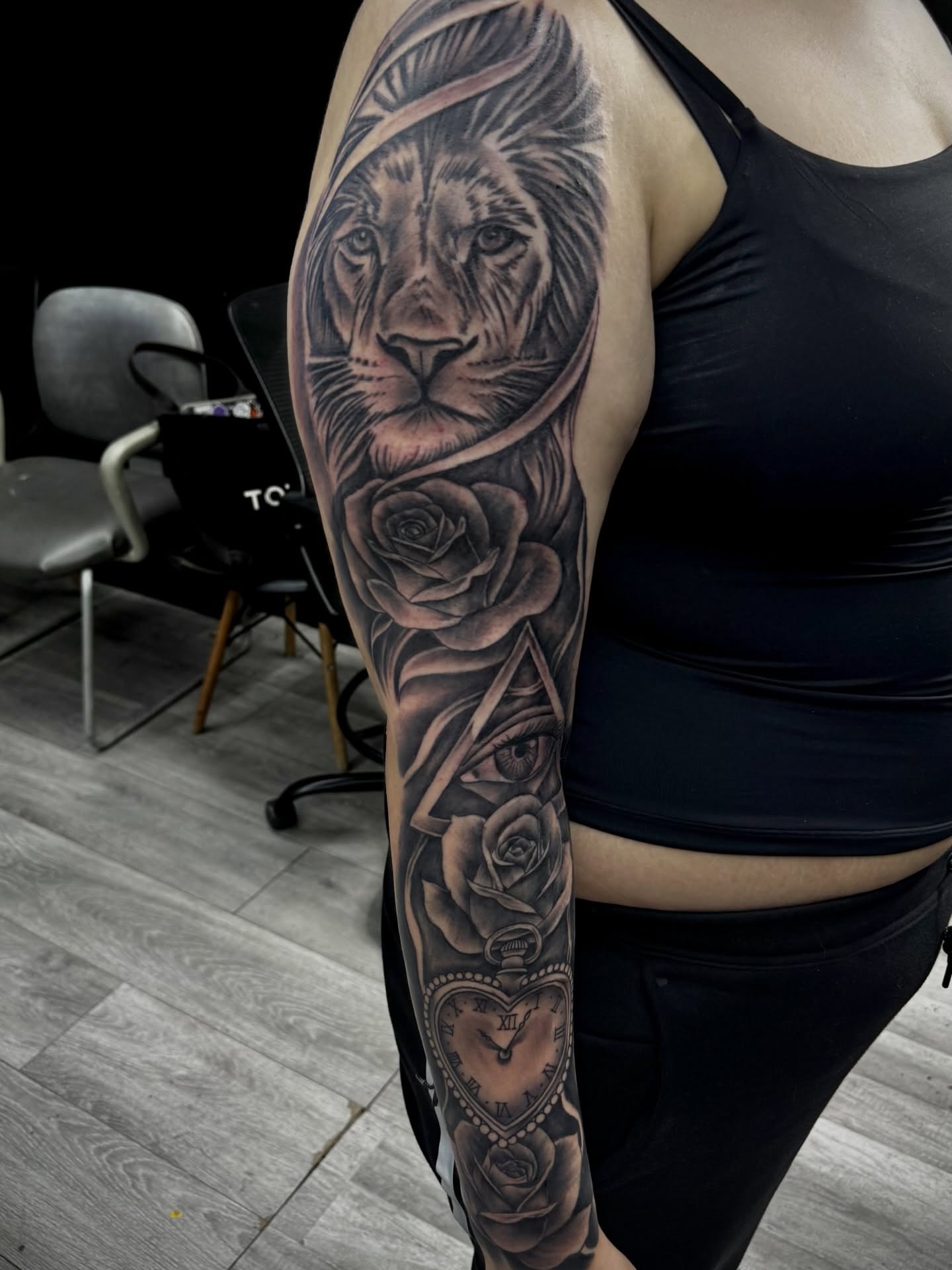 Lion and roses realism tattoo on the forearm by Zeus