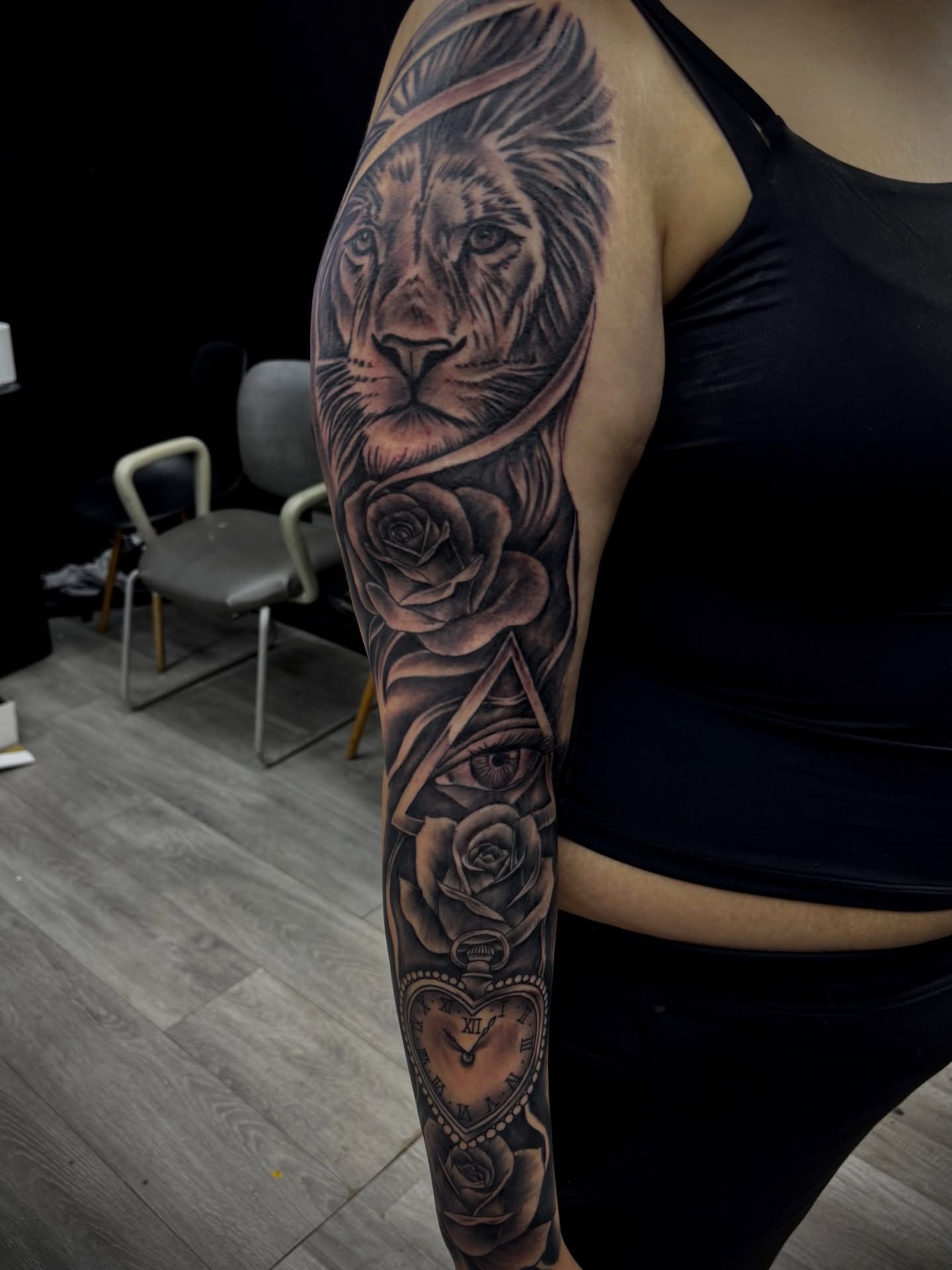 Lion and roses realism tattoo on the forearm by Zeus