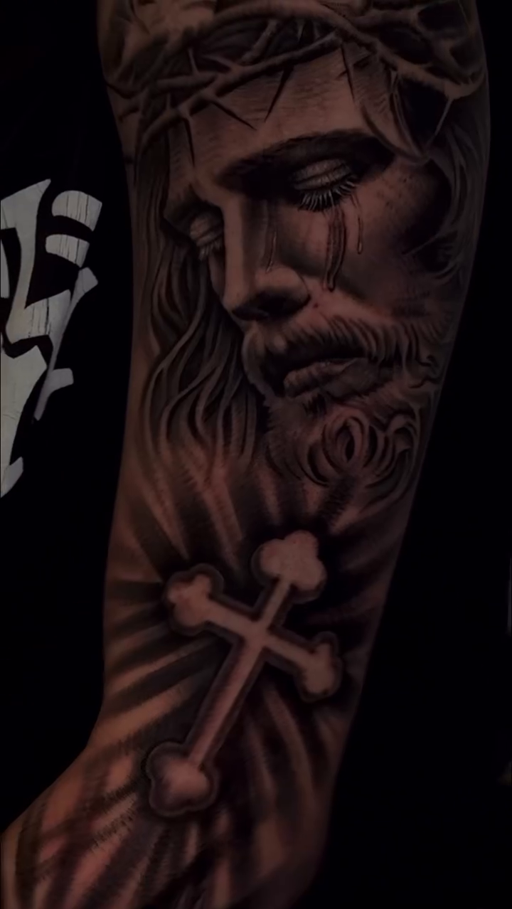 Jesus Christ with a cross realism tattoo by Henry Fuentes