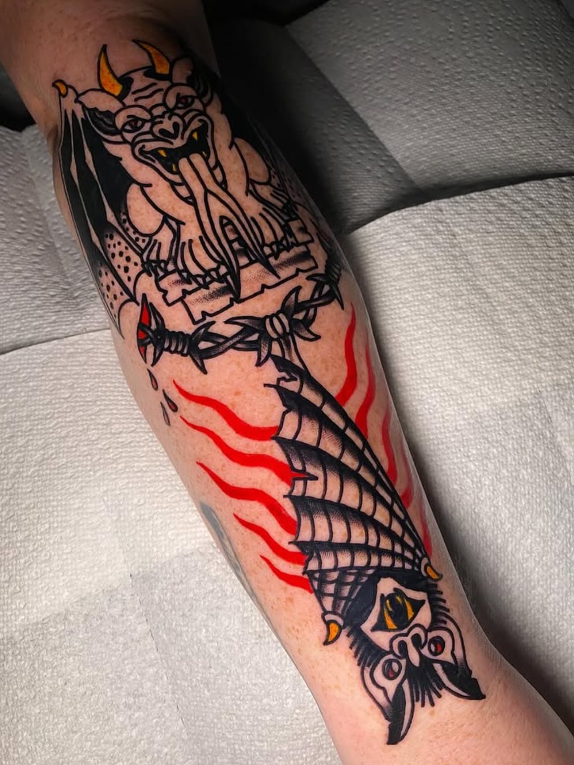 Demon and ship American traditional tattoo on the forearm by Nosferatu