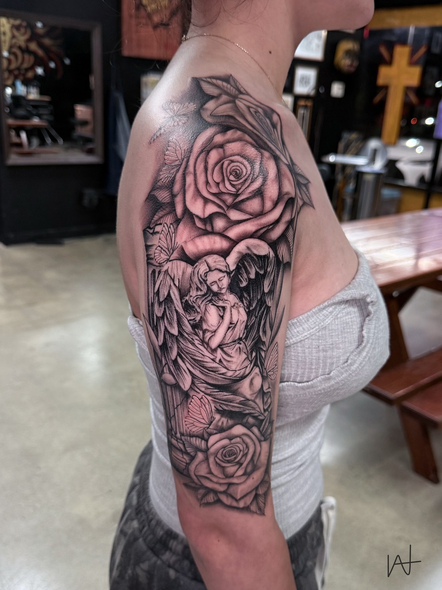 Angel with roses realism tattoo on the forearm by Kat Parmu