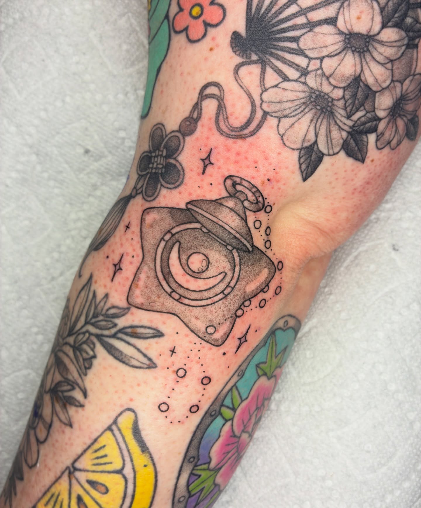 Space-themed device dotwork tattoo on the forearm by Lance 🦈