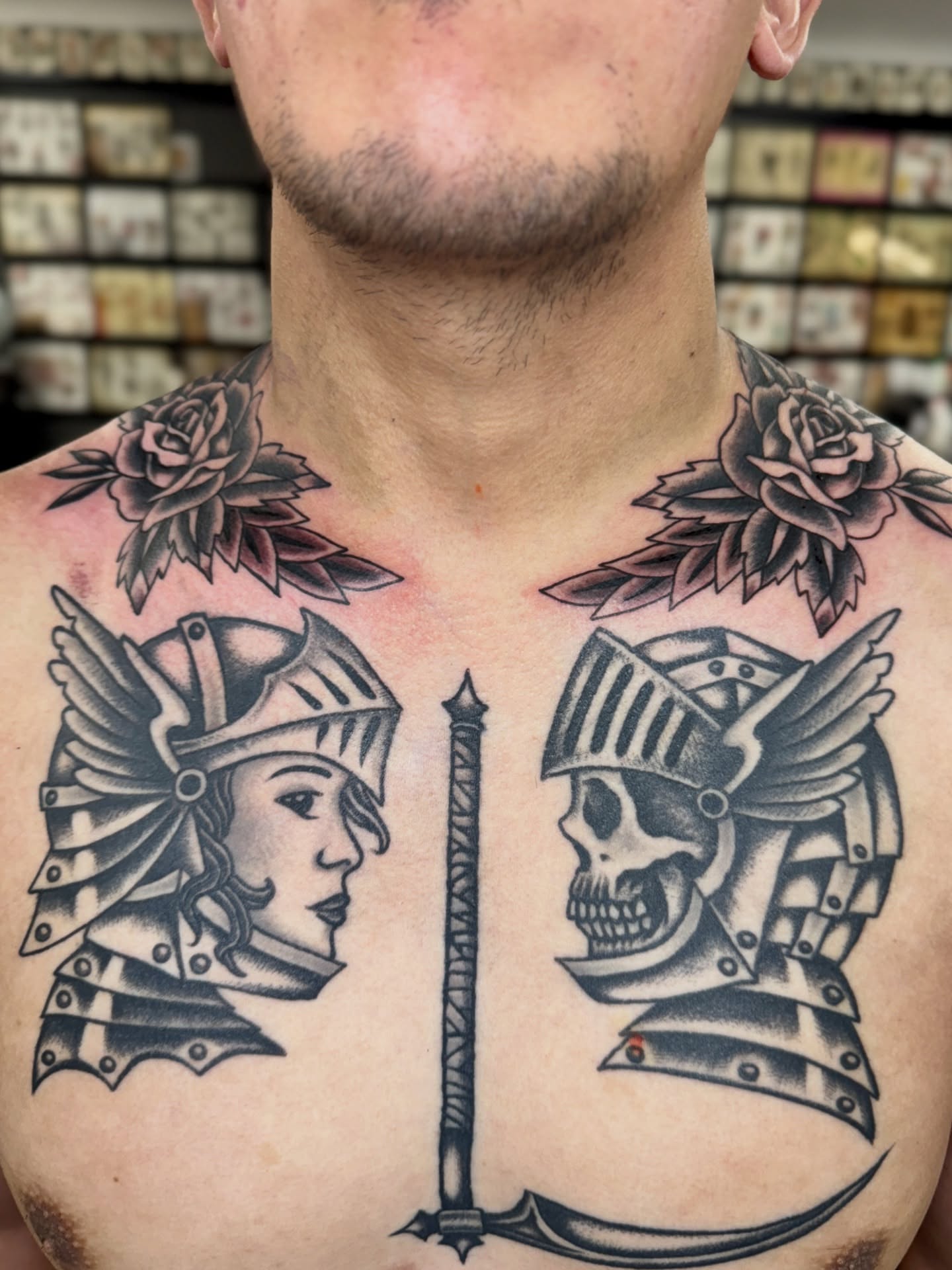 Warrior heads and sword American traditional tattoo on the chest by Sarah Pham