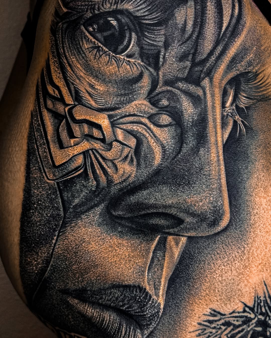 Face of a statue realism tattoo on the chest by Mak$ Brand