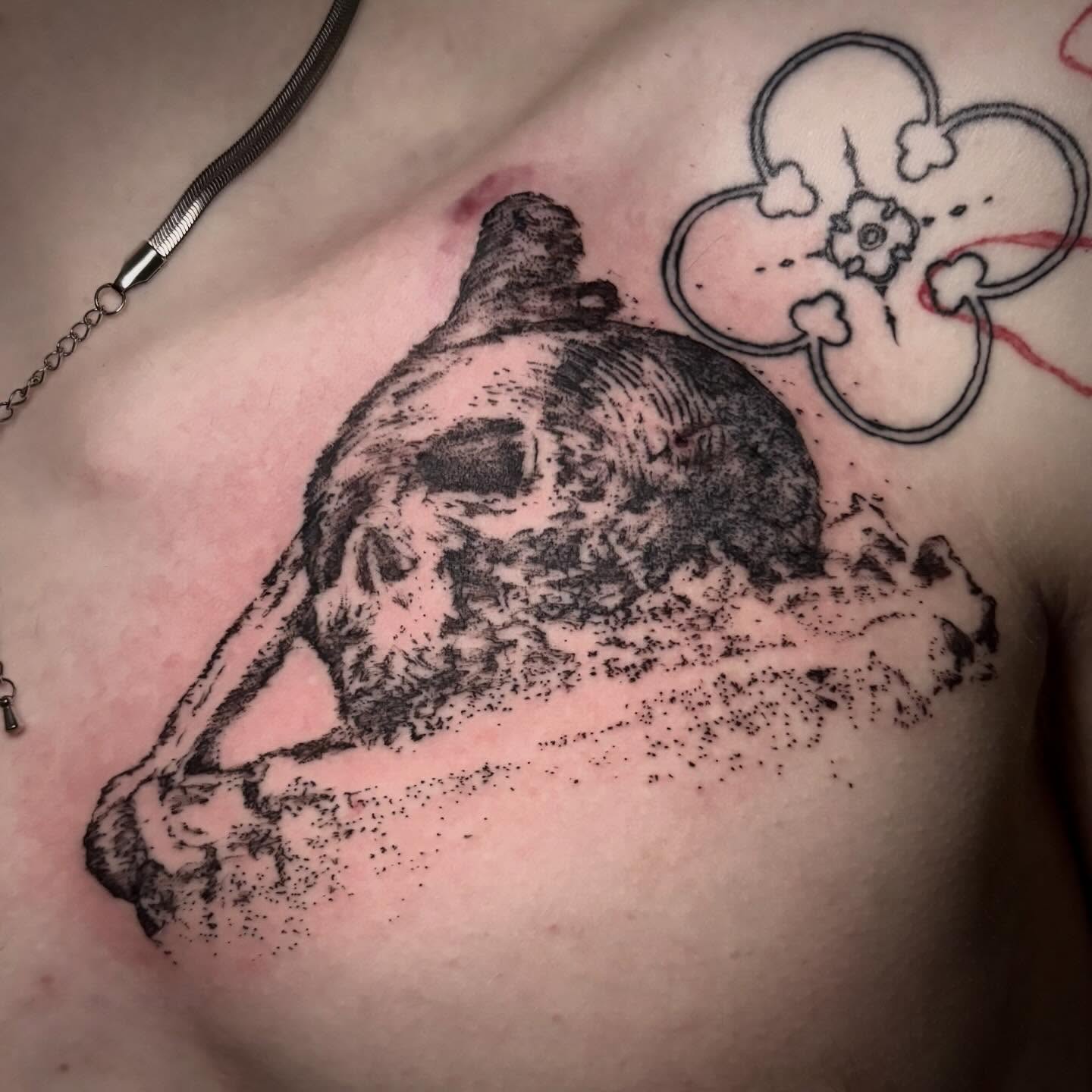 Skull and cloud dotwork tattoo on the chest by unknown liquids tattoo