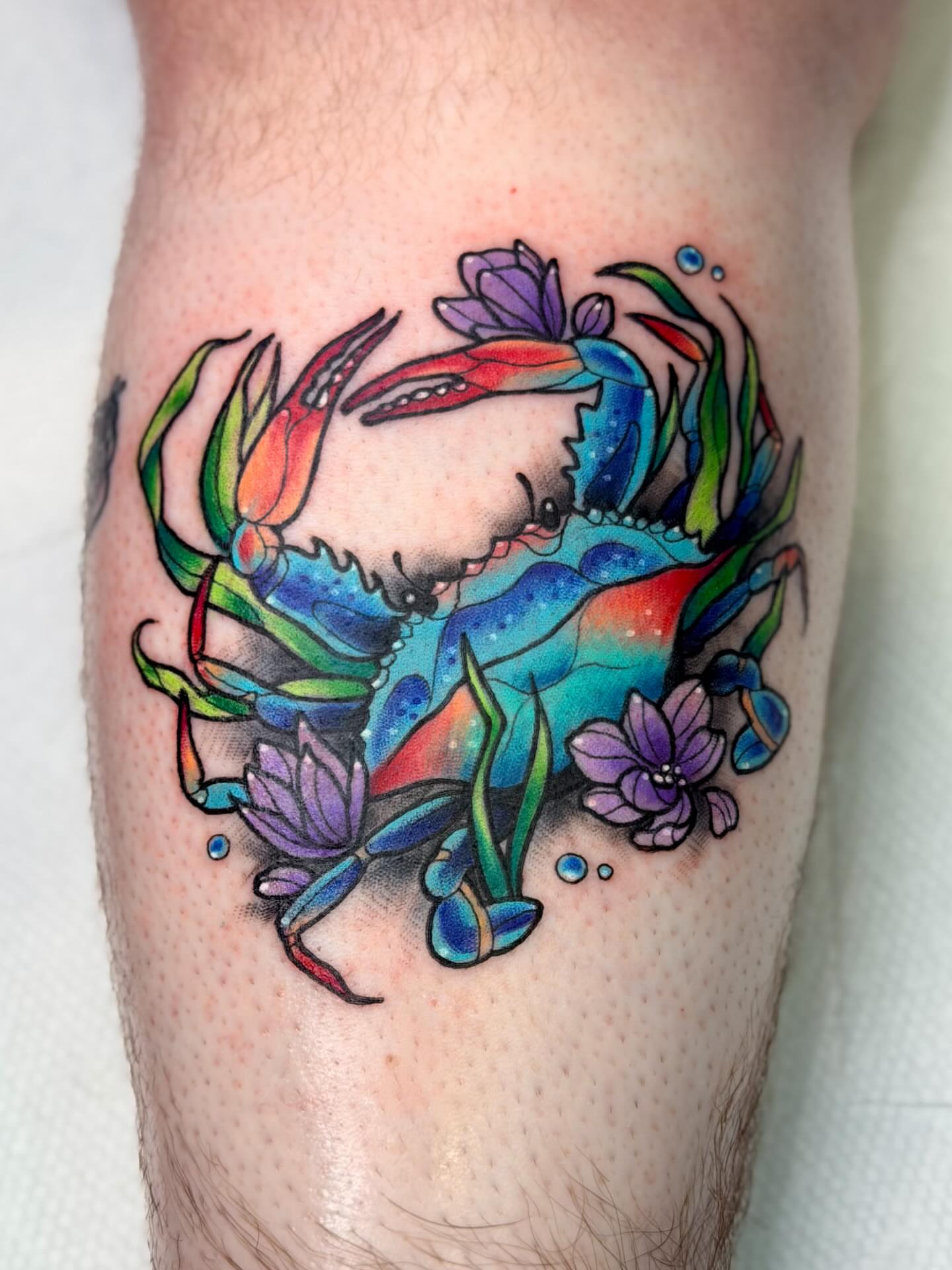 Crab and flowers new school tattoo on the thigh by Constance Roberts