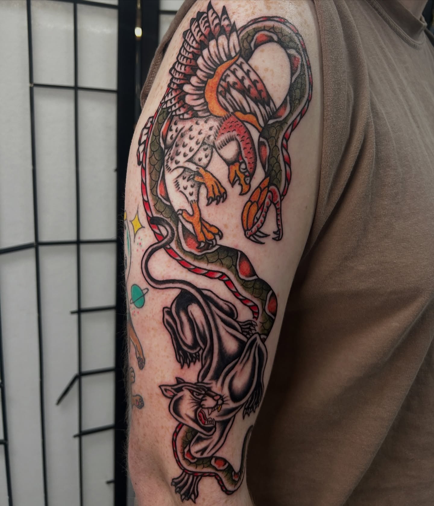 Dragon and phoenix American traditional tattoo on the forearm by Dylan James