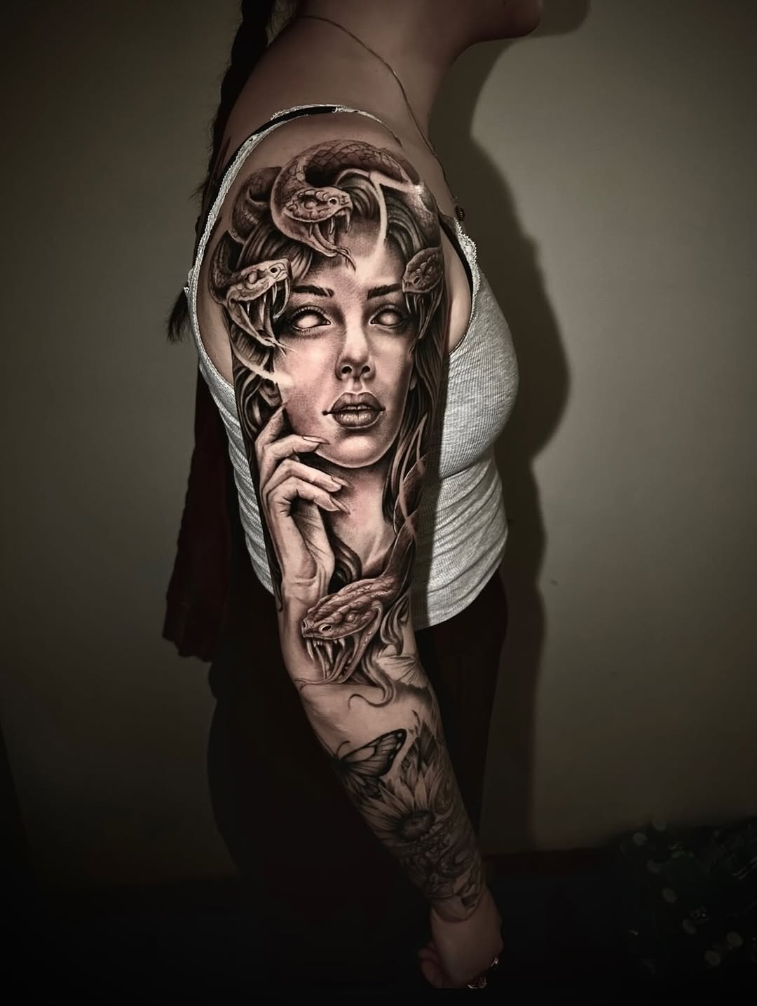 Medusa and snakes realism tattoo on the upper arm by Dylan Stevens