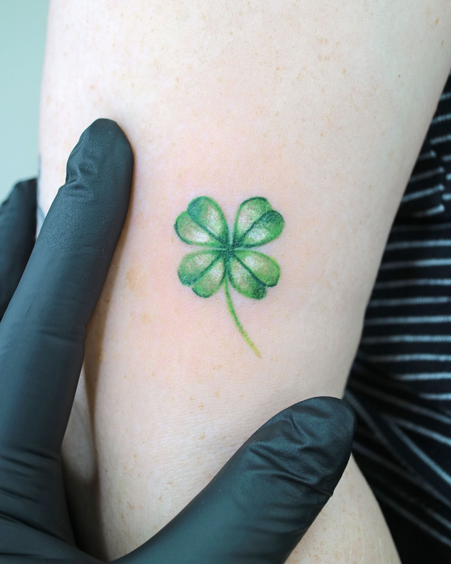 Four-leaf clover realism tattoo on the forearm by Aroha