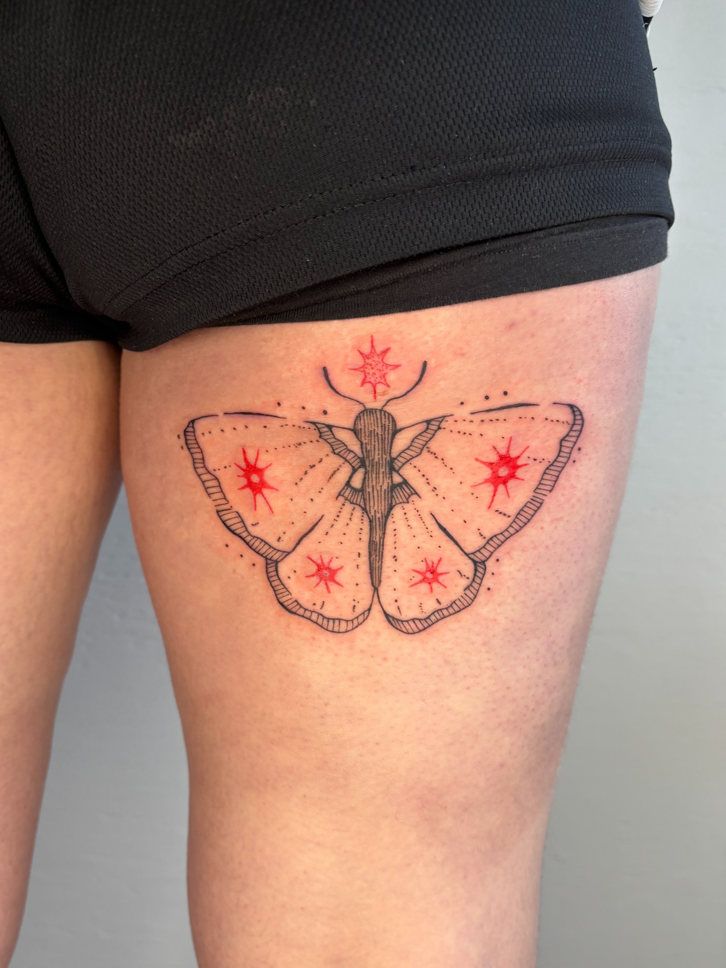 Butterfly dotwork tattoo on the thigh by Raye