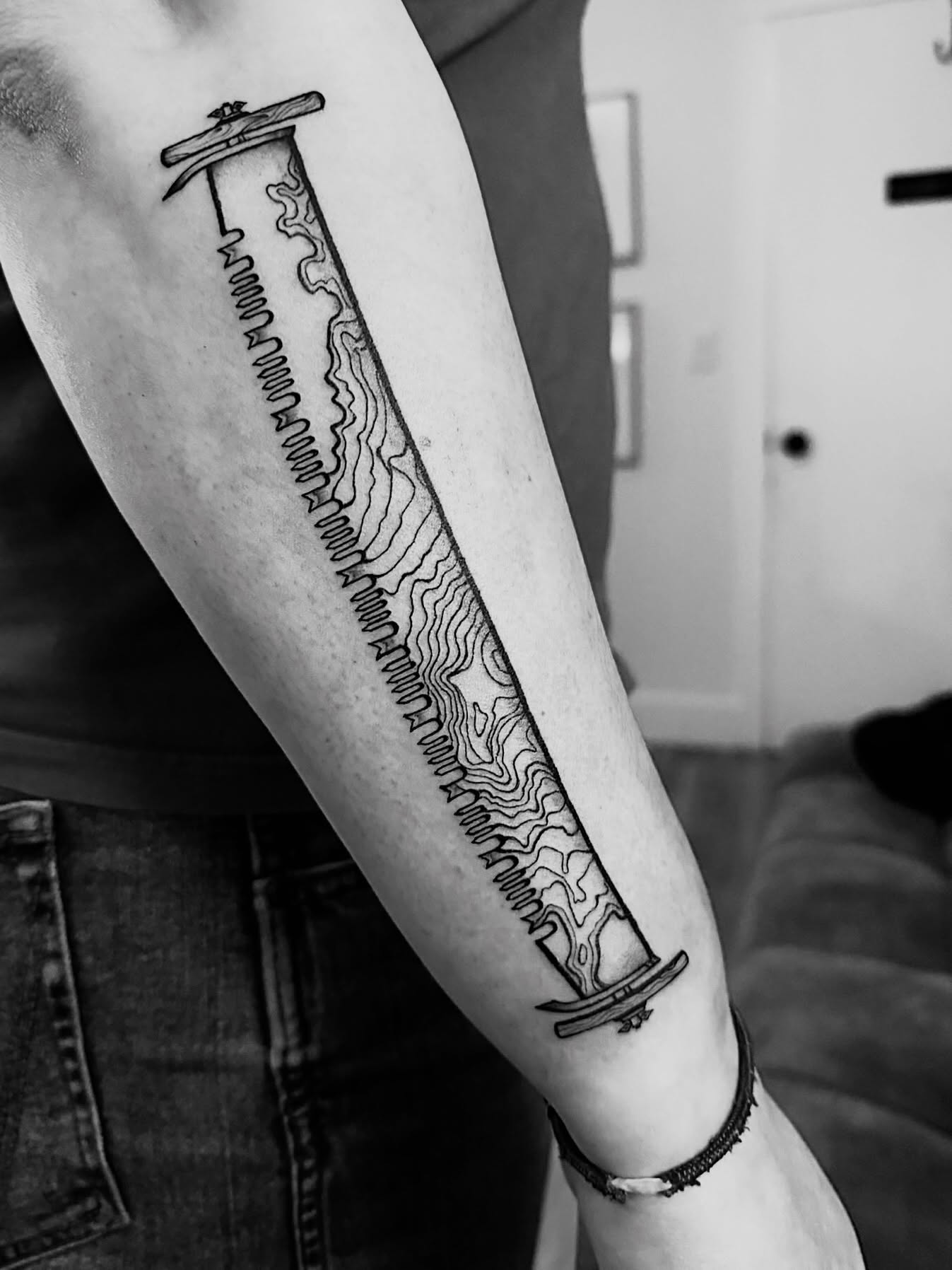 Topographic map geometric tattoo on the forearm by Kingtide Ink