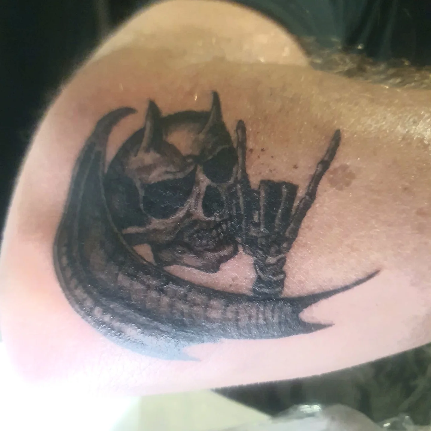 Skull and crown dark realism tattoo on the shoulder by Artful Ink