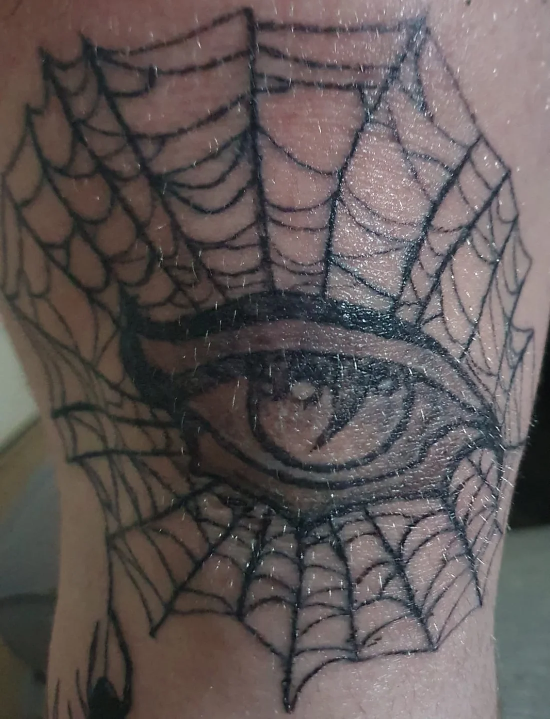 Eye within spiderweb geometric tattoo on the forearm by Artful Ink