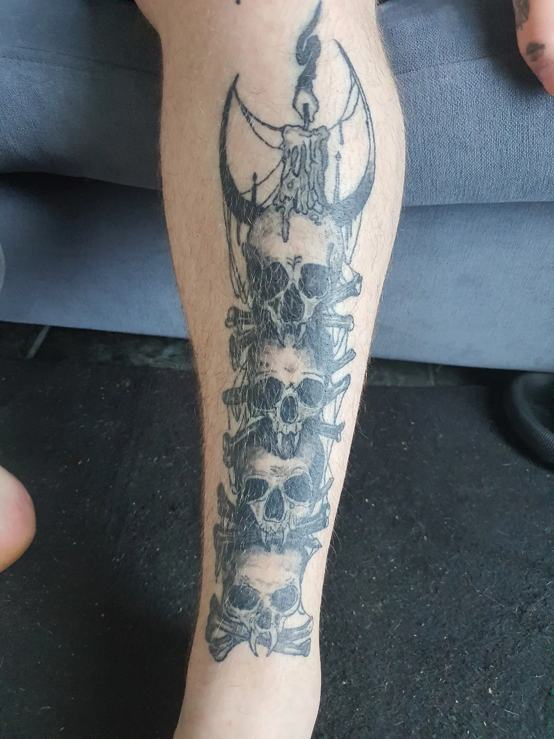 Skulls and horns black and grey tattoo on the forearm by Artful Ink