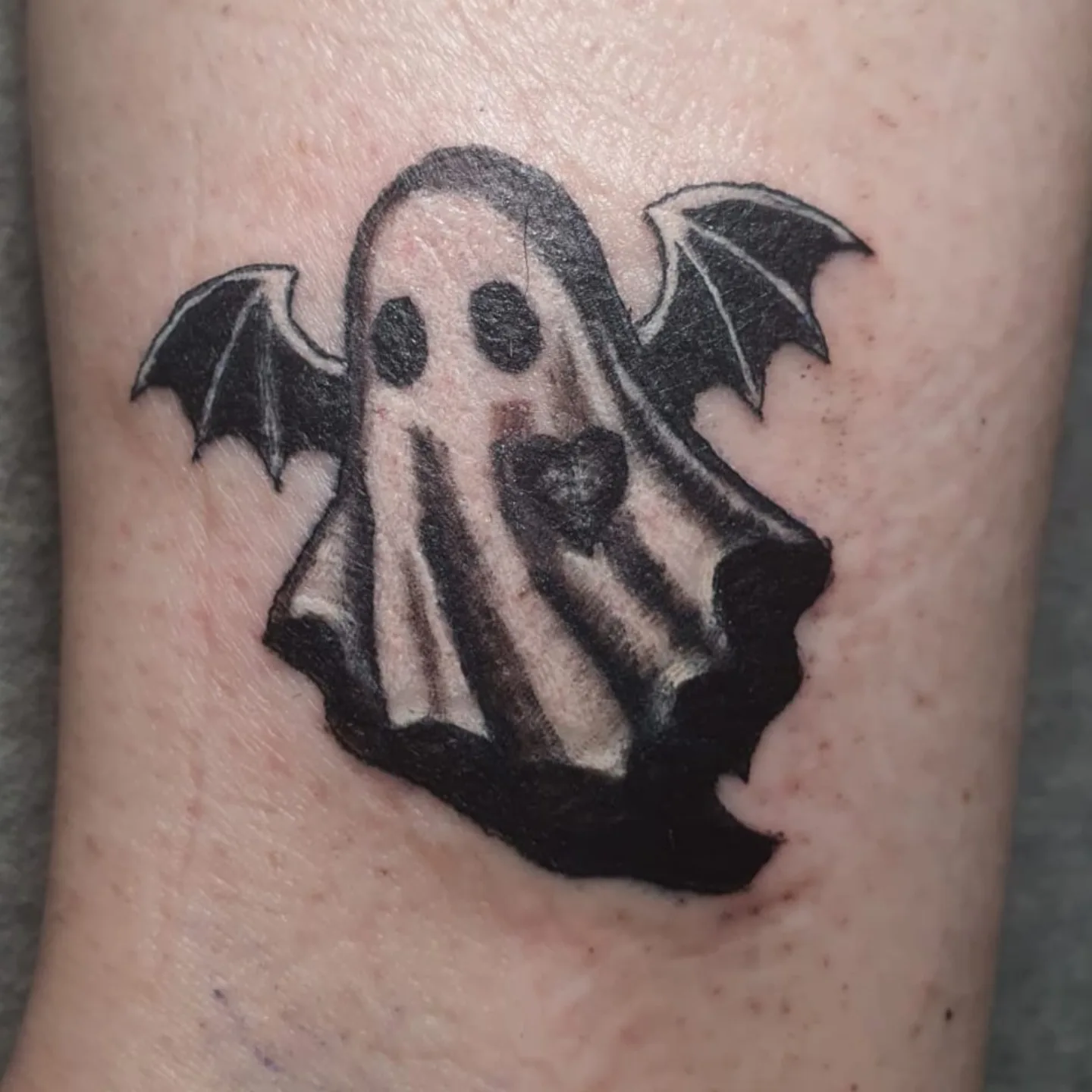 Ghost black and grey tattoo on the forearm by Artful Ink