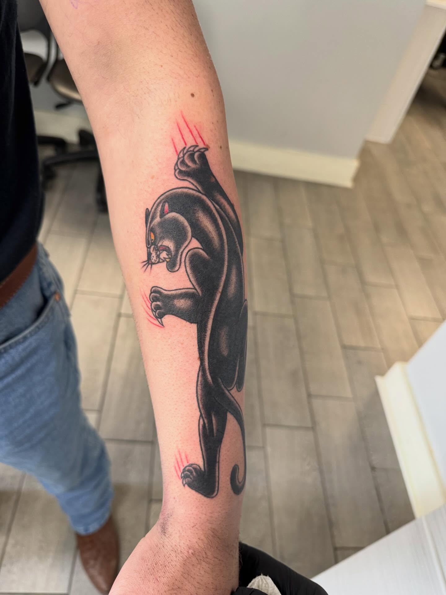 Panther American traditional tattoo on the forearm by Joey Flaherty