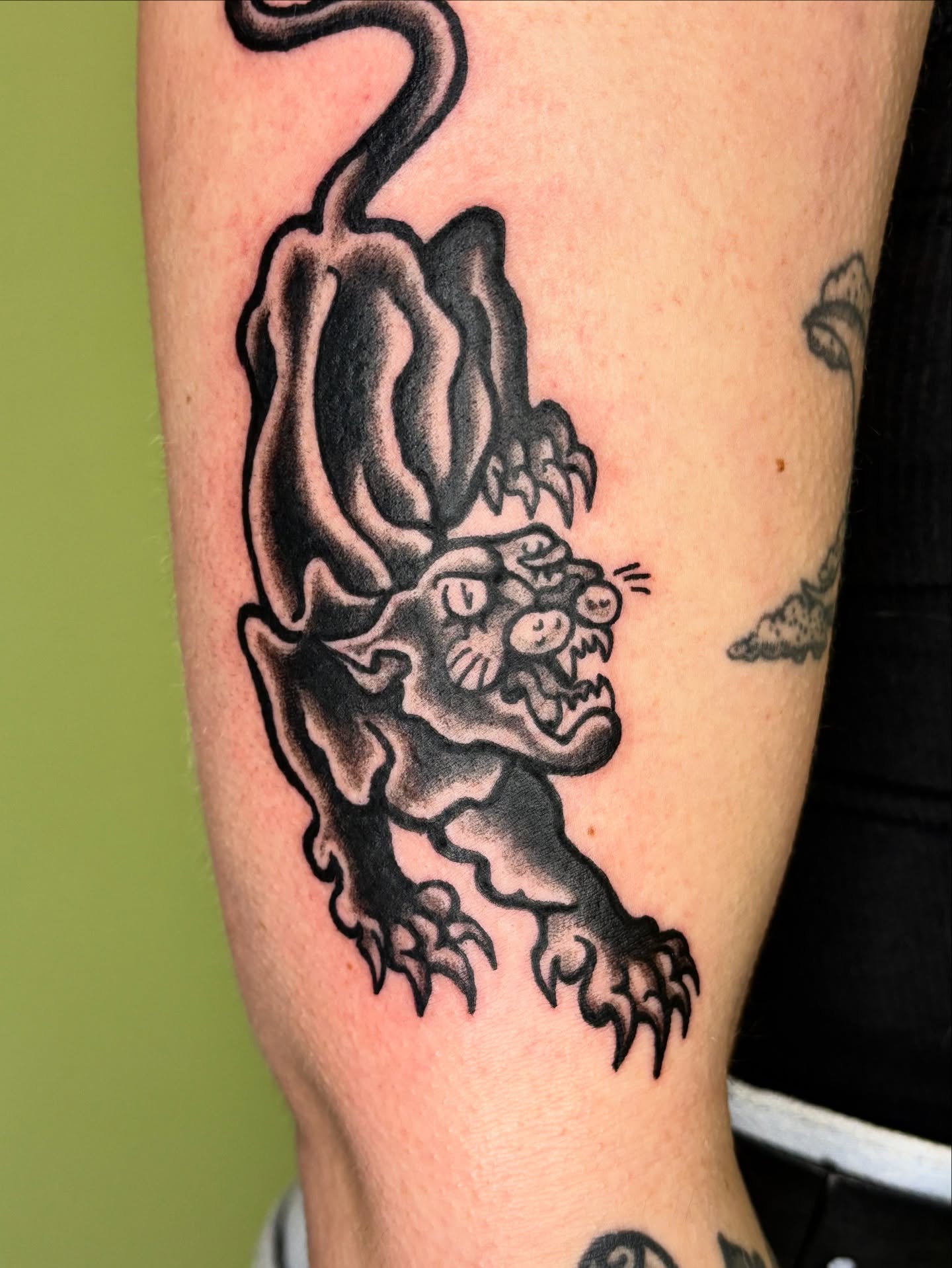 Panther black and grey tattoo on the forearm by Grae