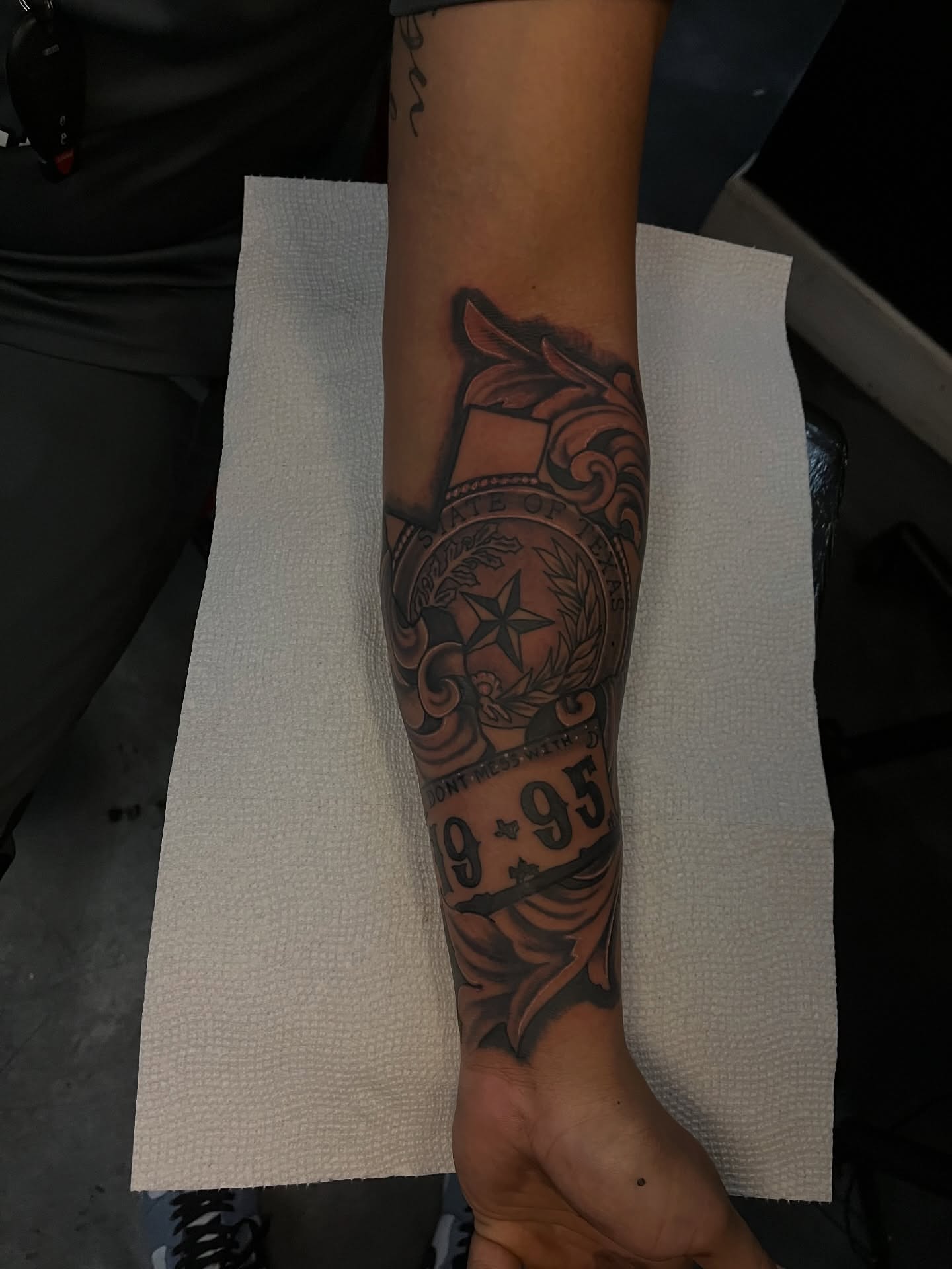 Coat of arms American traditional tattoo on the forearm by Dee