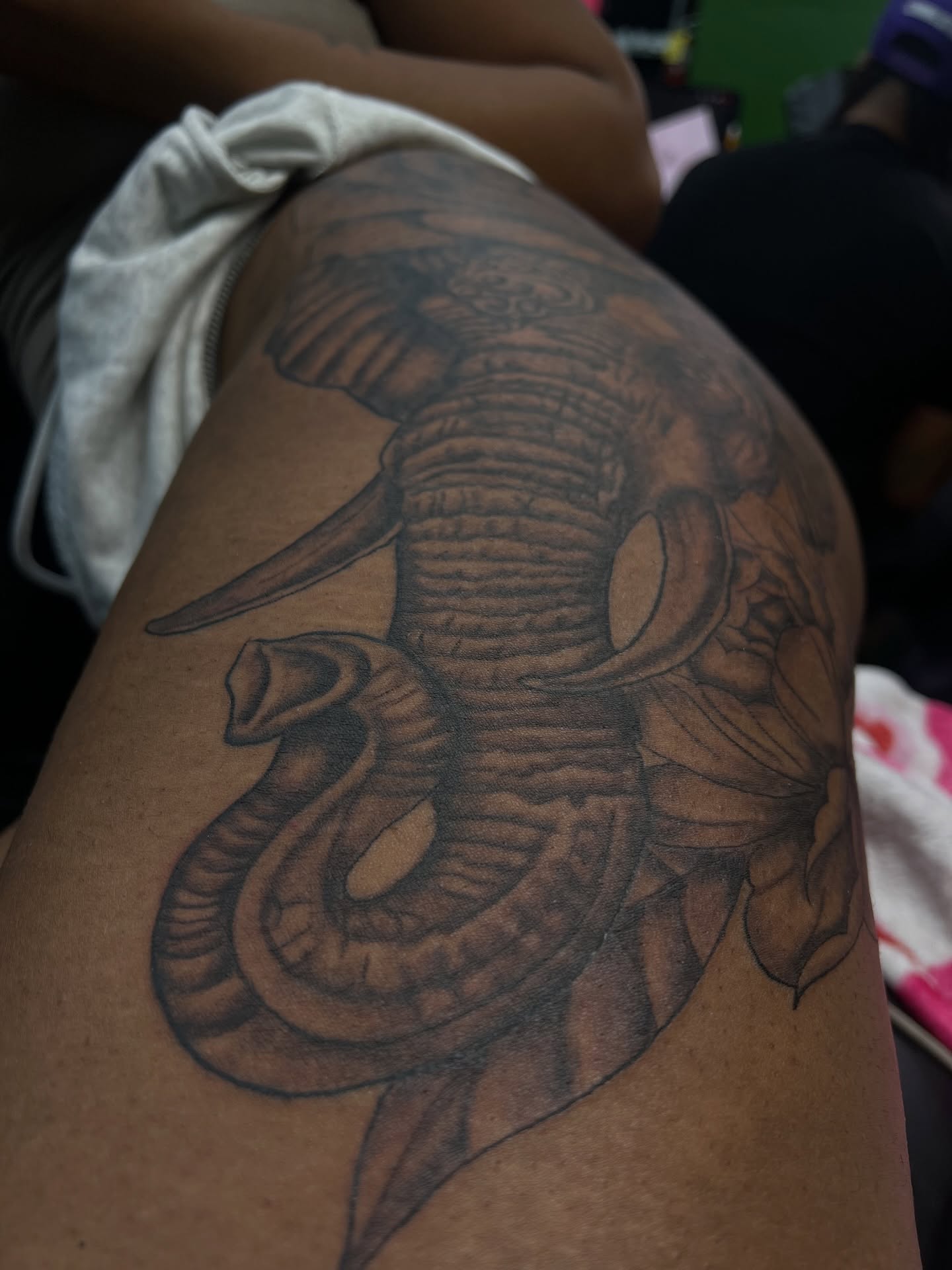 Elephant and snake black and grey tattoo on the thigh by Glass Inkk
