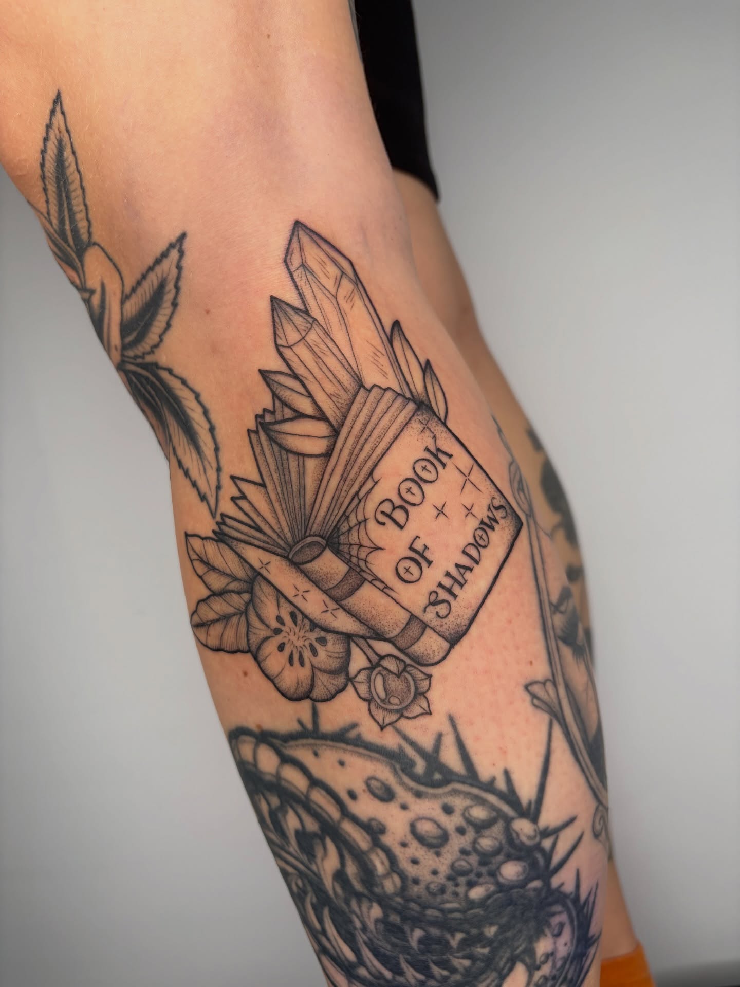 Book of shadows black and grey tattoo on the forearm by Poppy Olivia Deards