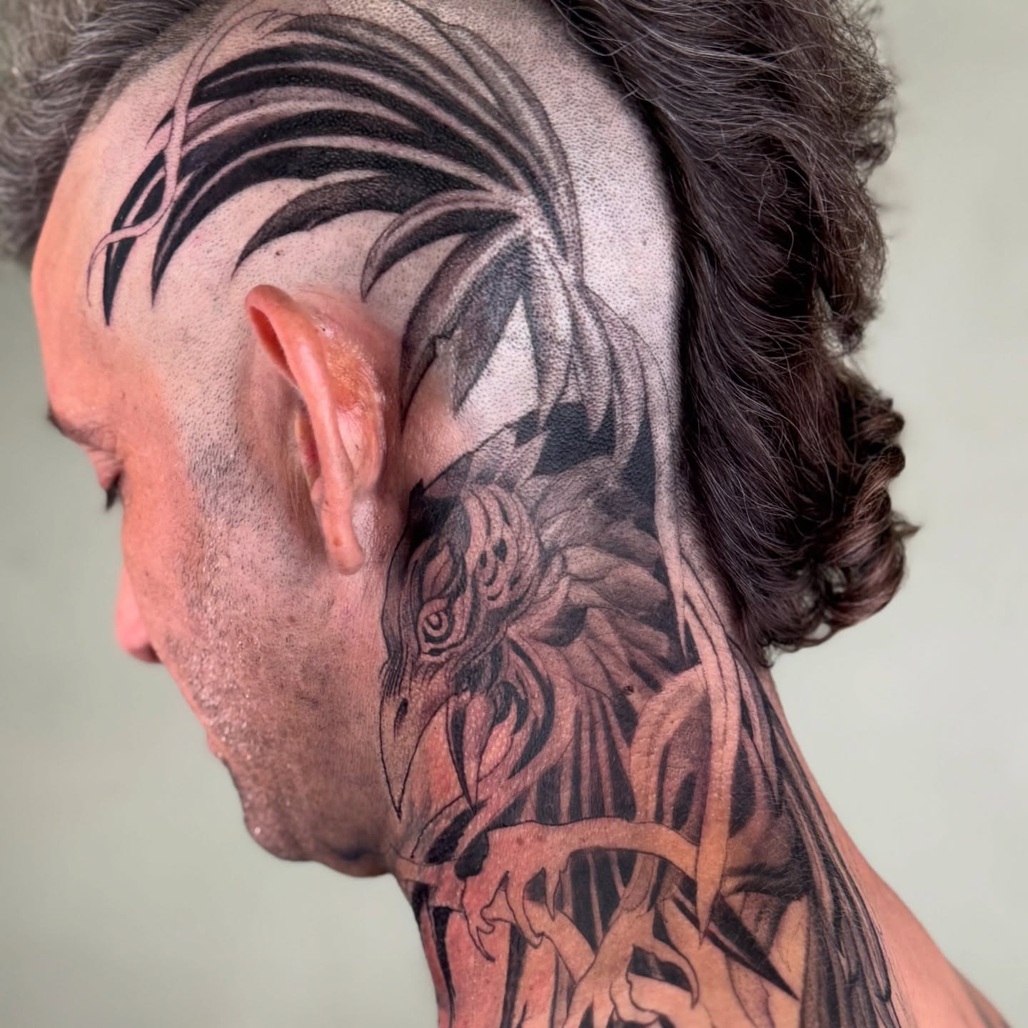 Bird black and grey tattoo on the neck by Erick Mendivil