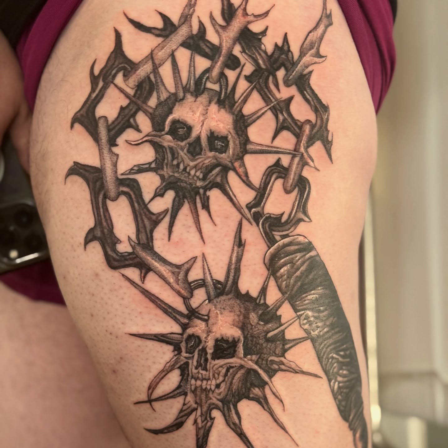 Skulls and thorns dark realism tattoo on the thigh by Erick Mendivil