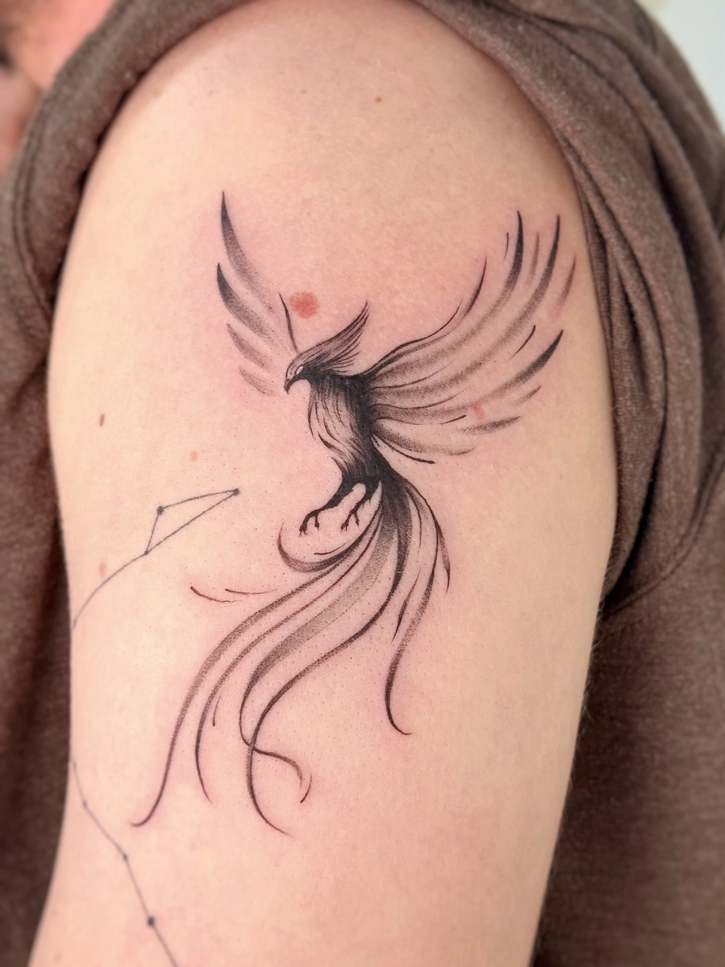 Phoenix black and grey tattoo on the shoulder by Gianna Rodriguez