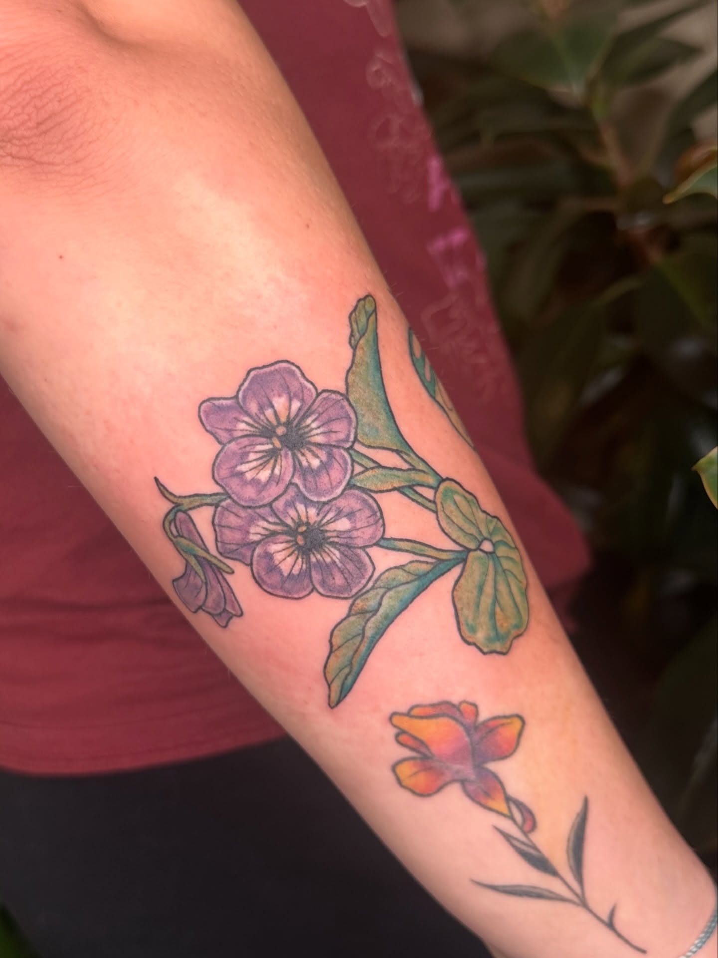Purple flowers realism tattoo on the forearm by Ransom