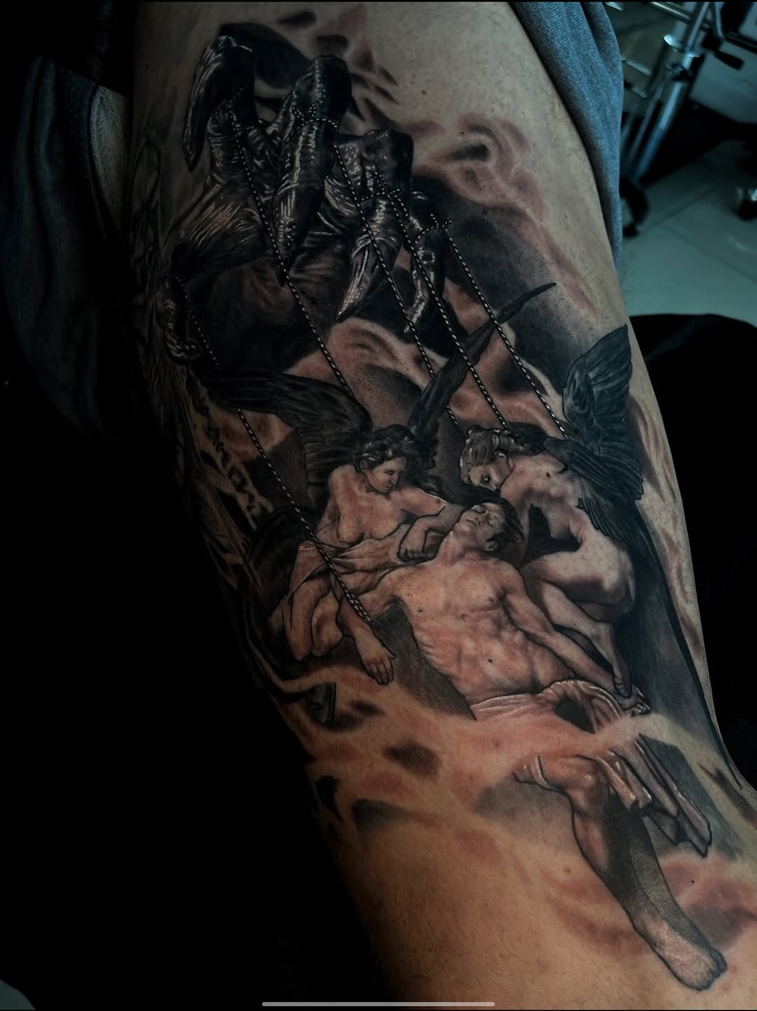 Angelic figures holding a man realism tattoo on the forearm by Tattoo Artist