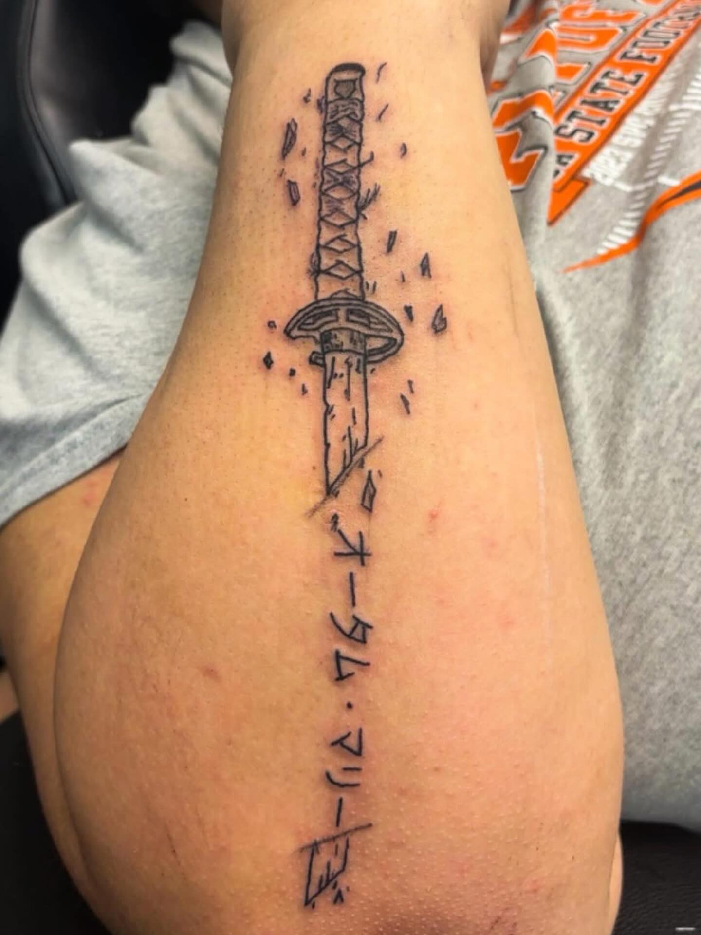Katana black and grey tattoo on the forearm by Syneca Wilson, Acton, Massachusetts