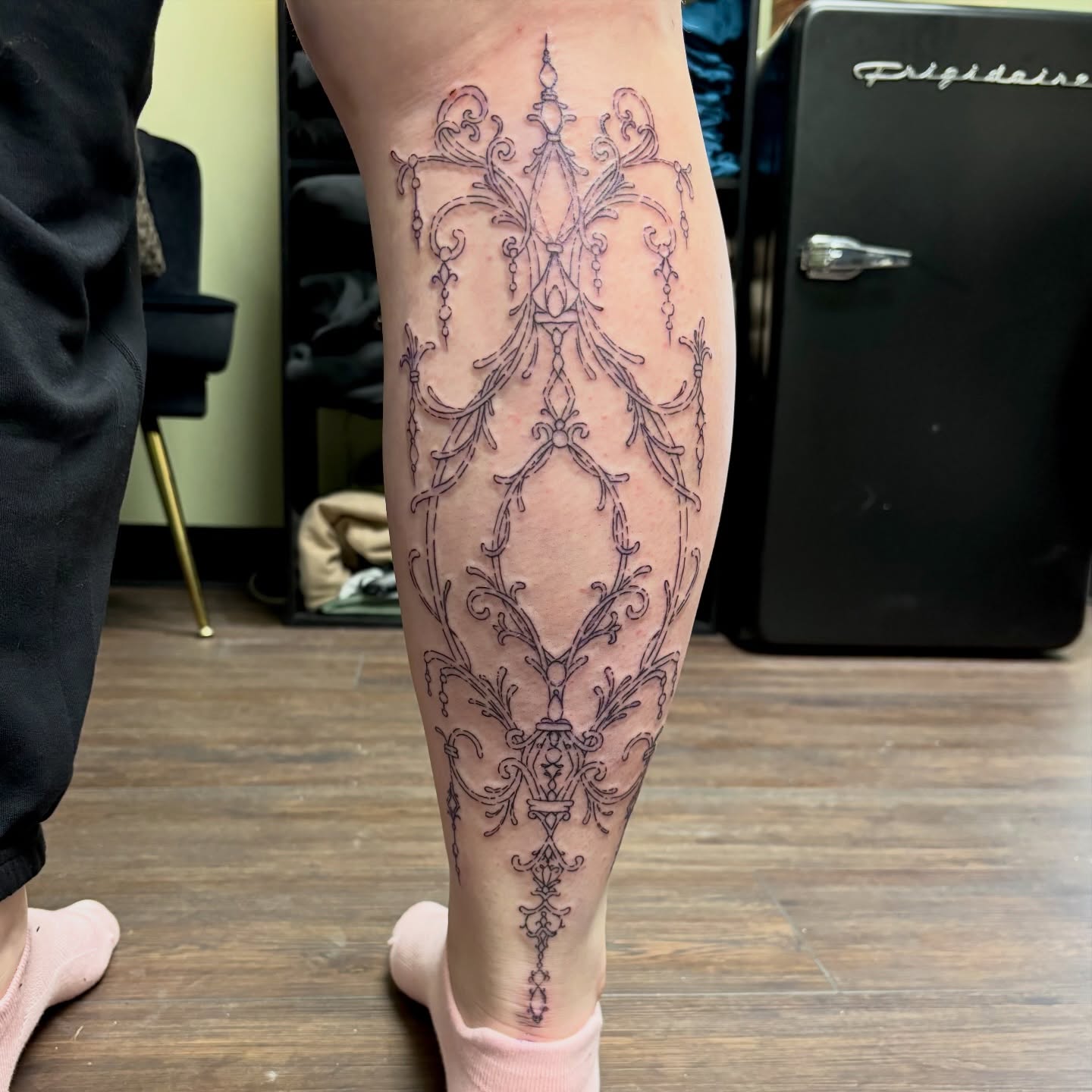 Chandelier ornamental tattoo on the calf by sydney honn