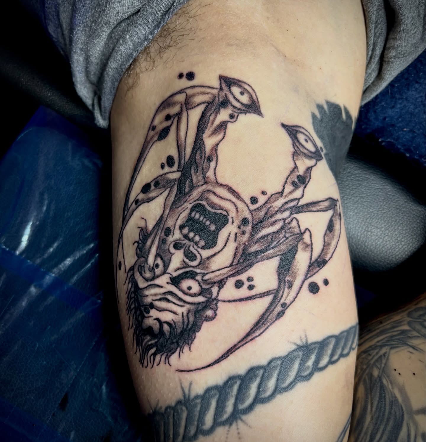 Skull with tentacles trash polka tattoo on the thigh by Rayne