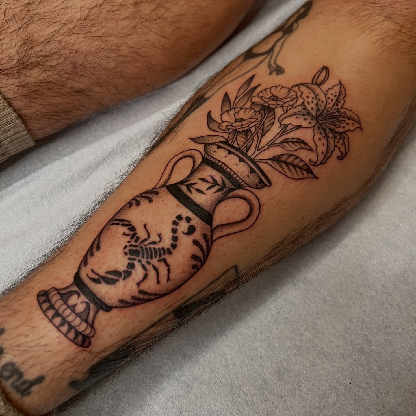 Vase with flowers black and grey tattoo on the forearm by @syrenbier, San Francisco, California