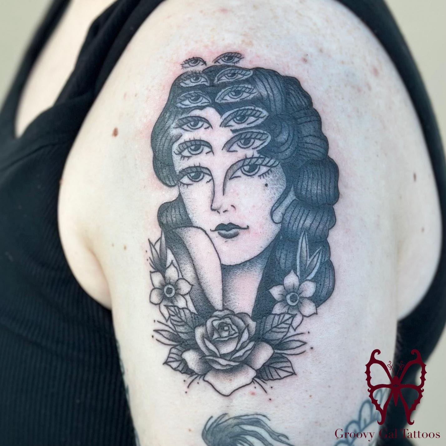 Woman with eyes dotwork tattoo on the shoulder by Groovy P