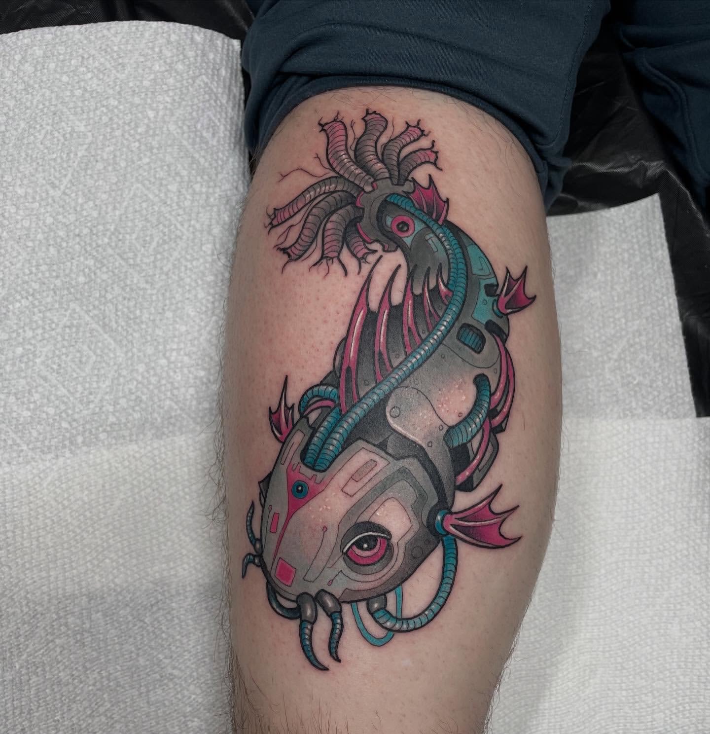 Cyborg fish geometric tattoo on the thigh by Nathan Evans