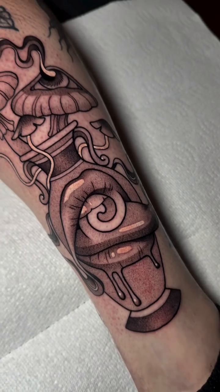 Potion bottle and eye dark realism tattoo by Bell Bolton