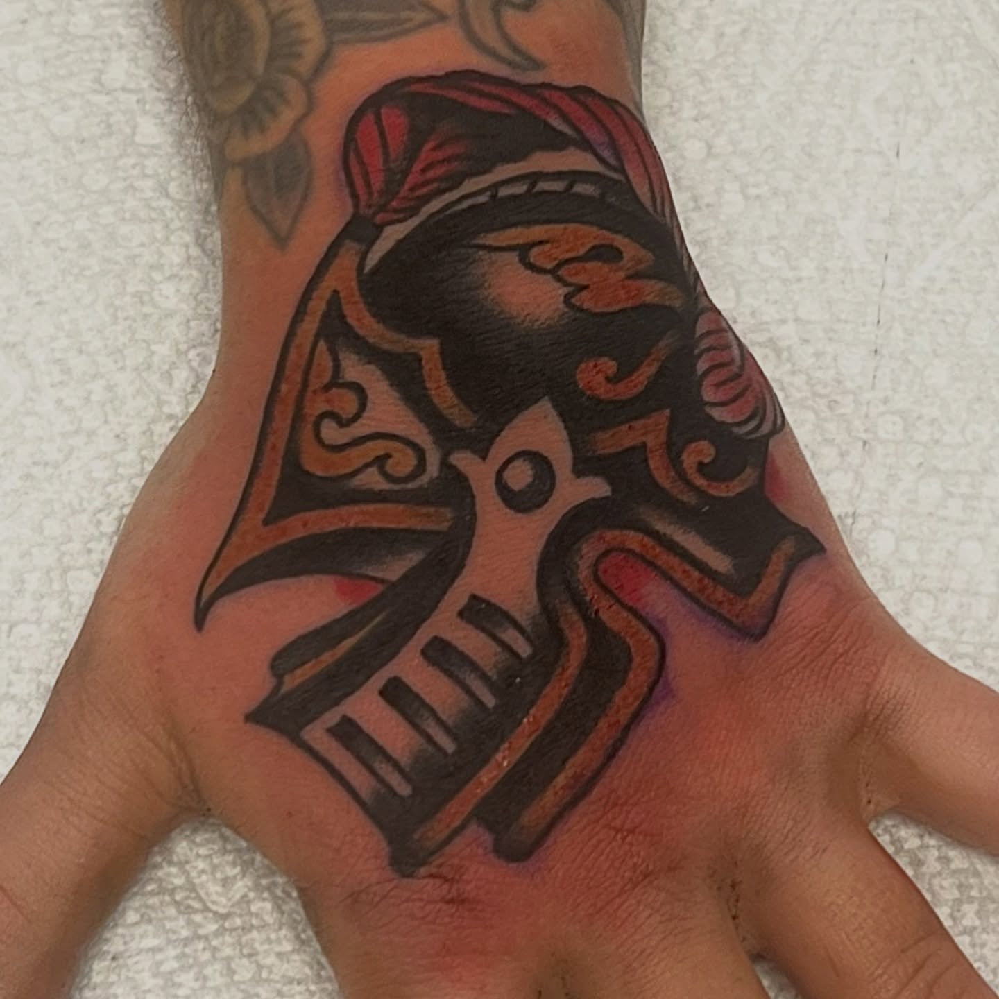 Mask American traditional tattoo on the hand by @brandonhuckabey, Denver, Colorado