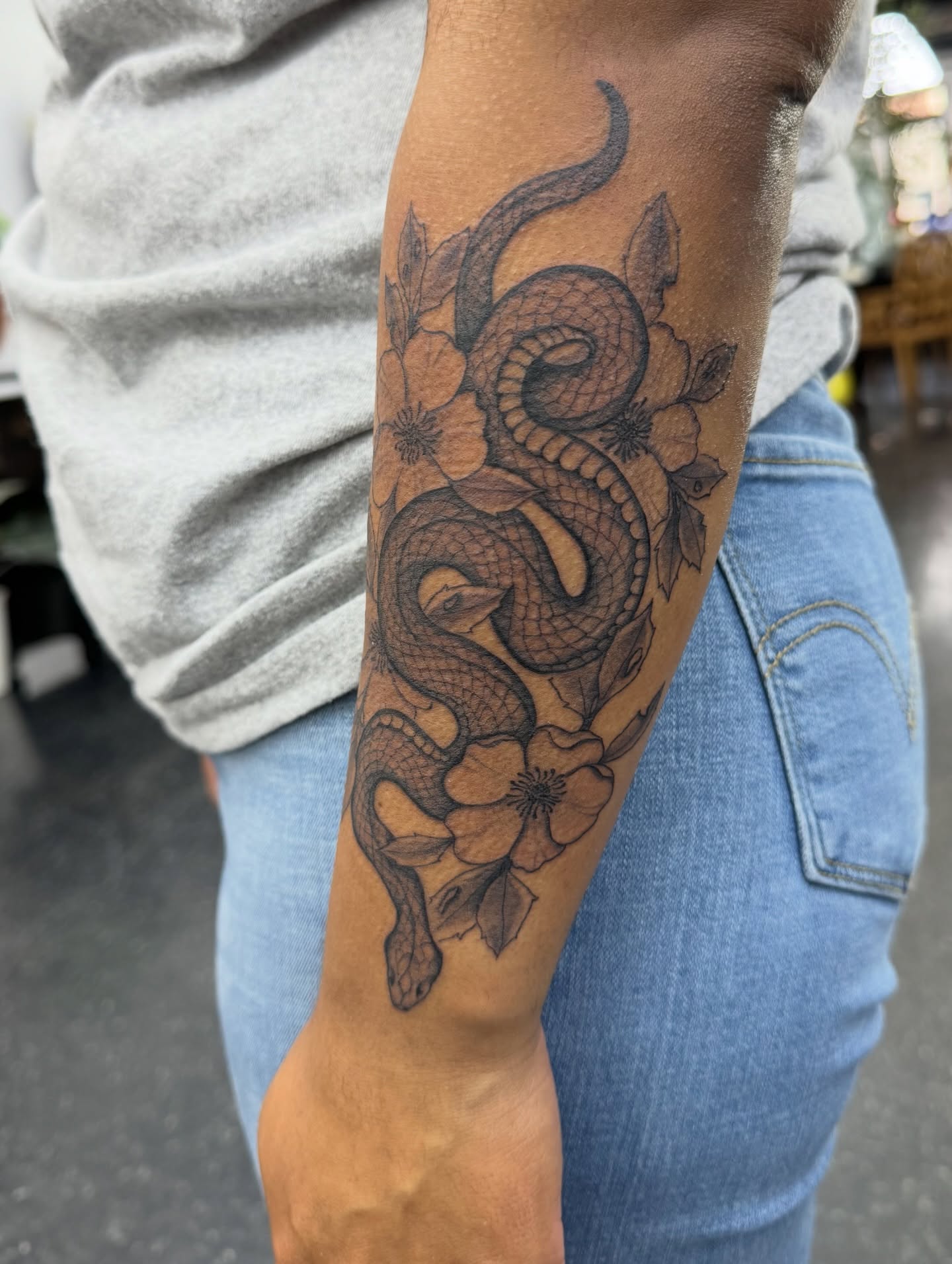 Snake and flowers black and grey tattoo on the forearm by πππππ¨π¨ ππ«ππ’π¬π