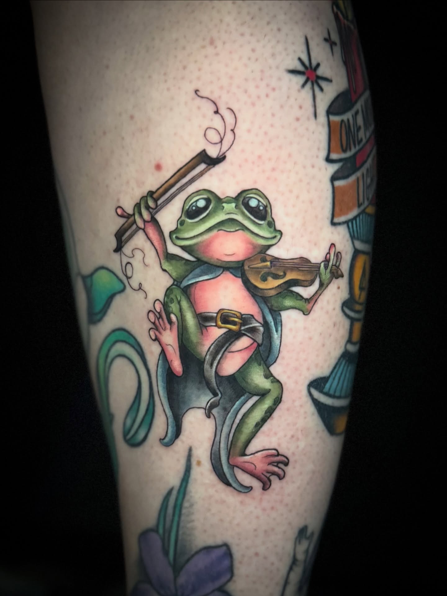 Frog playing violin American traditional tattoo on the forearm by M A D I E I N S P A N I E R π¦ tattoos