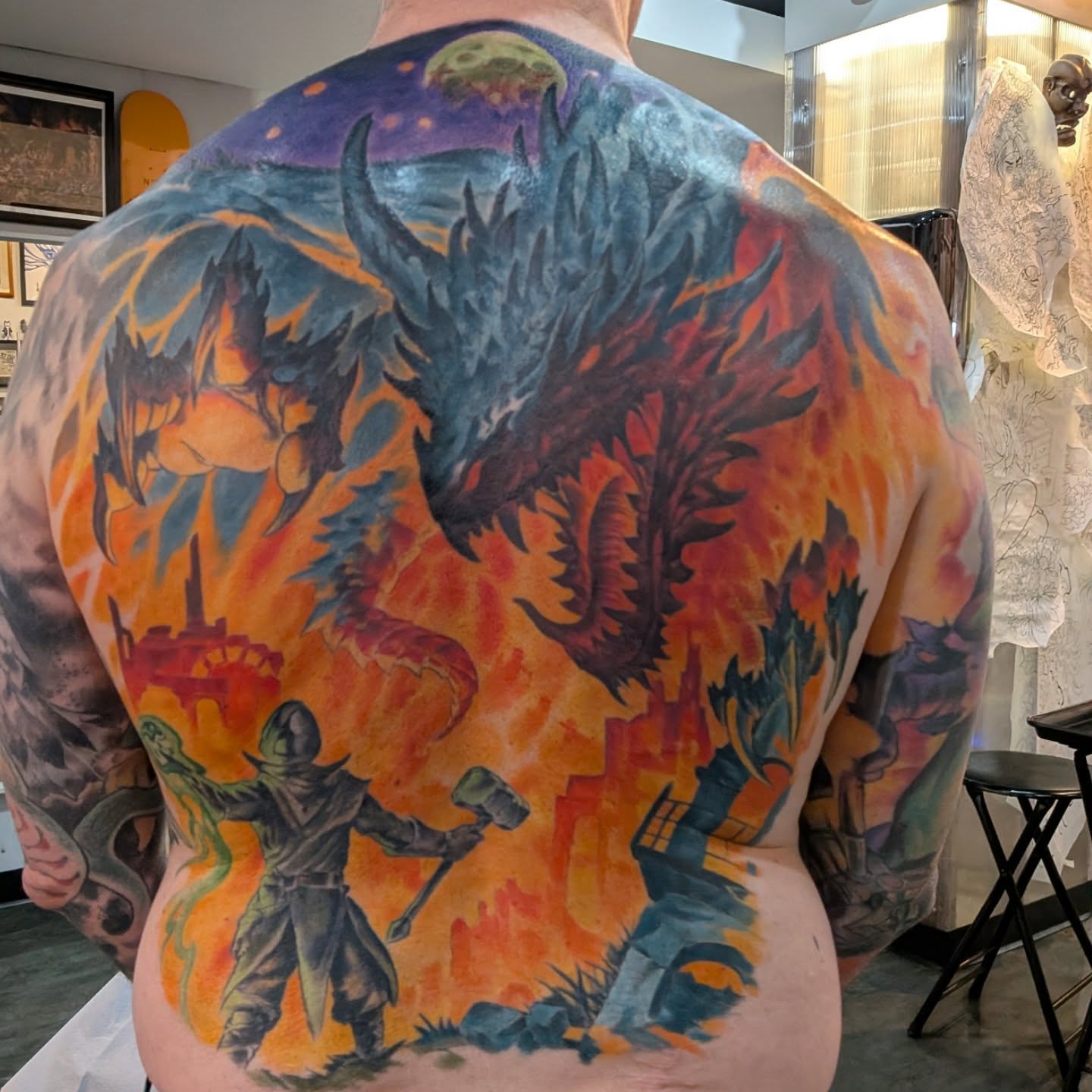 Dragon battle scene illustrative tattoo on the back by Nic Skrade, Minneapolis, Minnesota