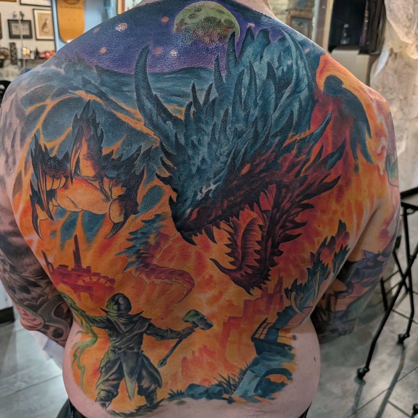 Dragon battle scene illustrative tattoo on the back by Nic Skrade, Minneapolis, Minnesota