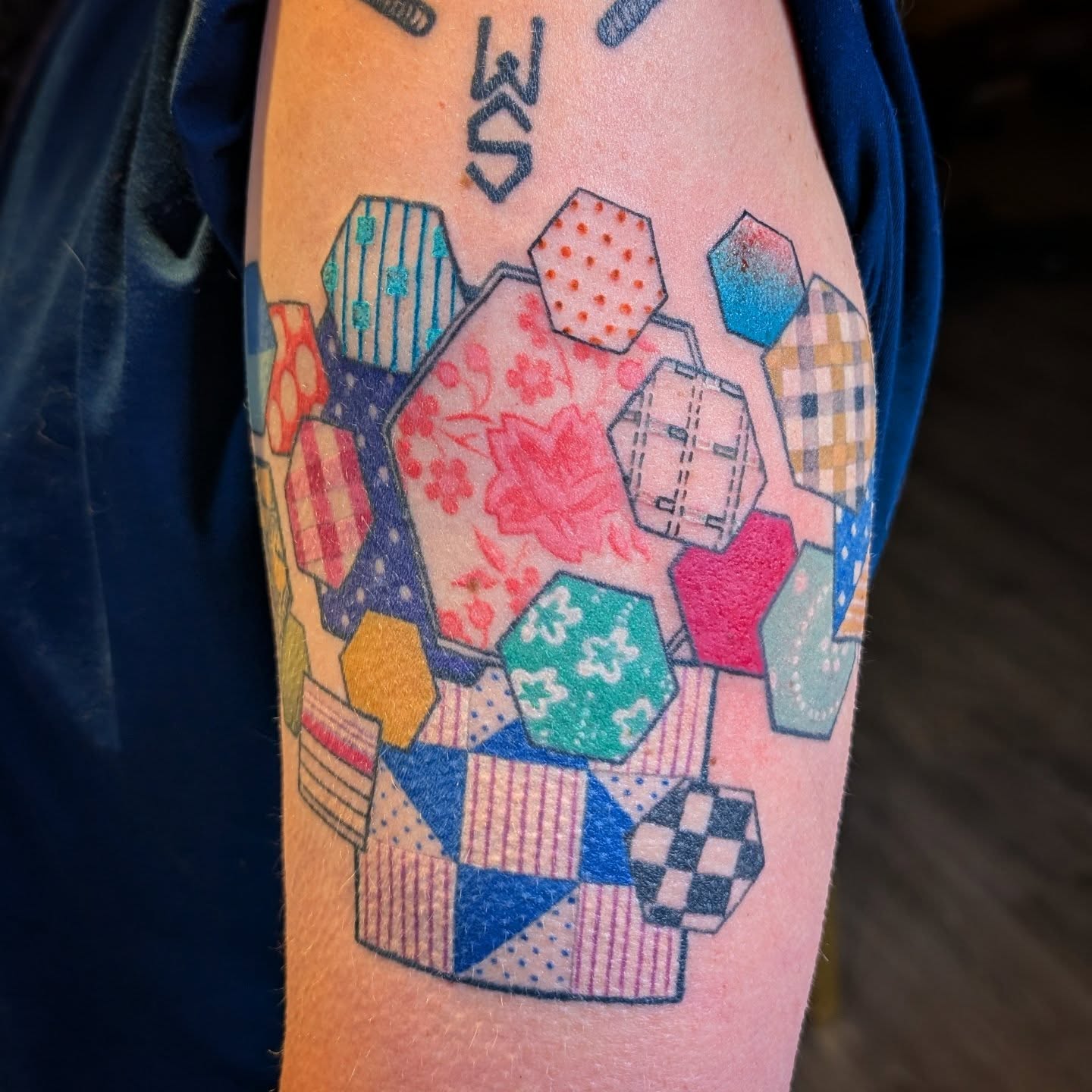 Patchwork quilt geometric tattoo on the forearm by Michaela May