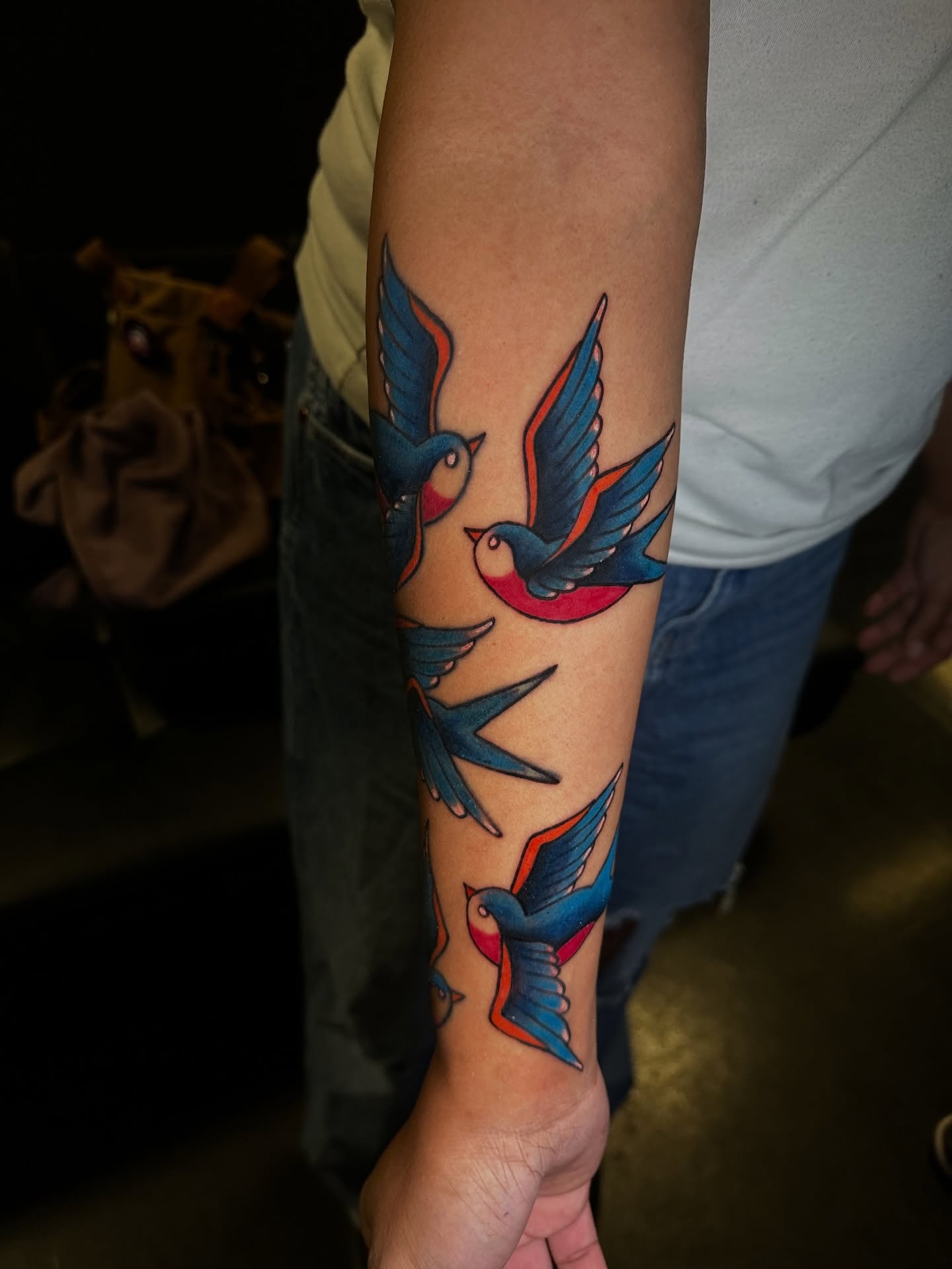 Swallows American traditional tattoo on the forearm by Angel Tattoos