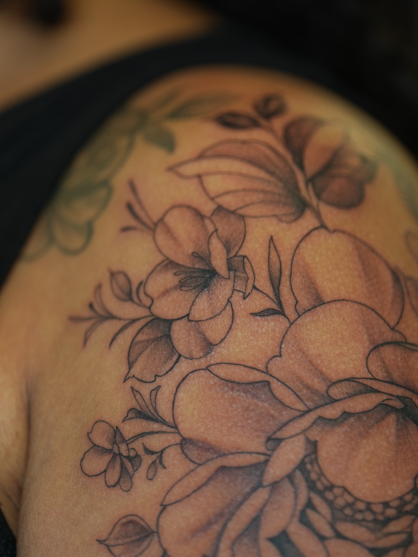 Floral bouquet black and grey tattoo on the shoulder by Kevin Betancourt