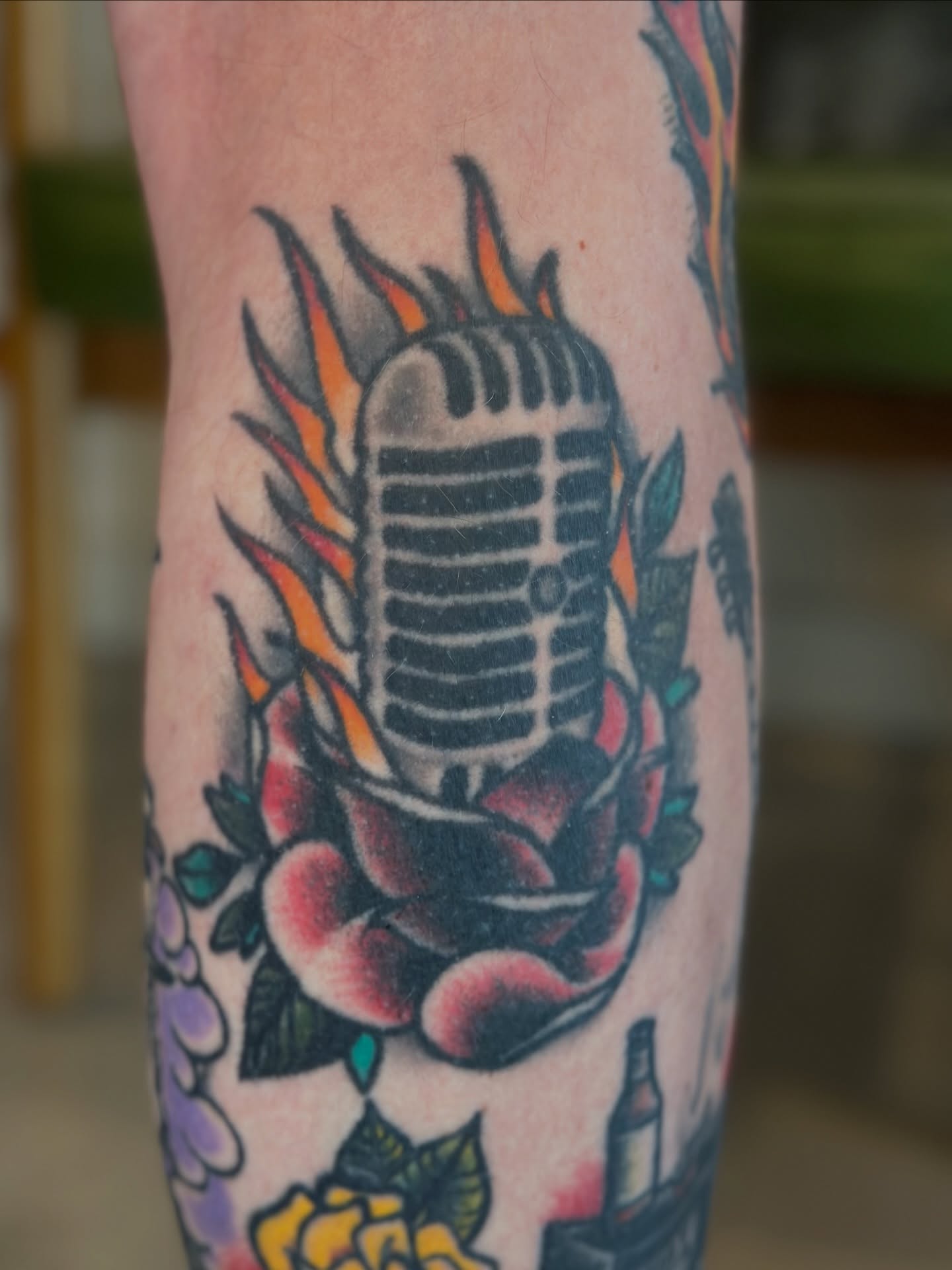 Microphone and rose American traditional tattoo on the forearm by Michael Williams